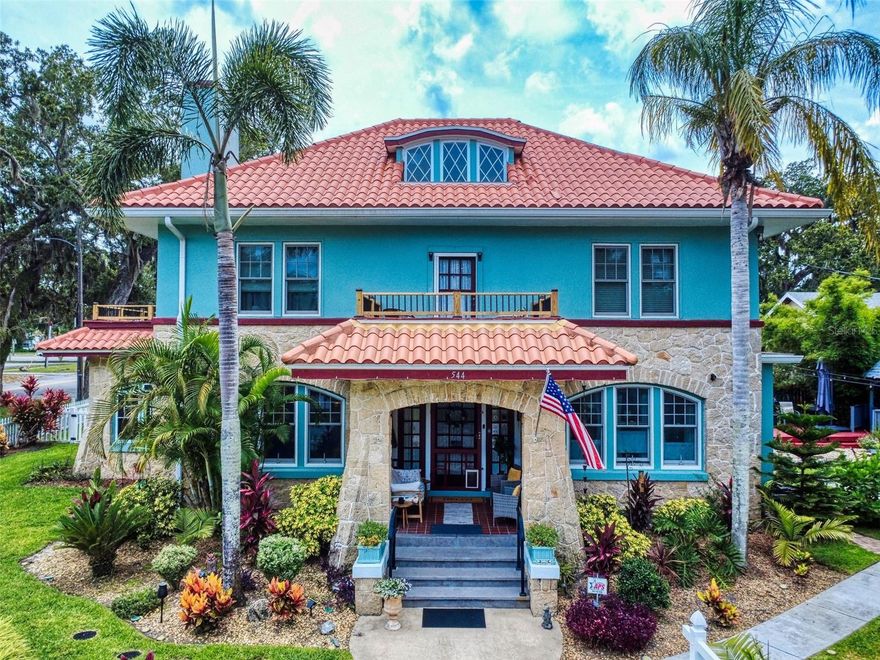 Florida Charm Meets Turnkey Opportunity! This 1912 Historic Registry Home is a rare gem located in the residential Historic District of Downtown Daytona Beach—offering incredible flexibility as a private residence or fully operational Bed & Breakfast. Just minutes from the Daytona International Speedway, Daytona Beaches, and one block from the 500-slip marina, the location blends lifestyle and investment potential. Set on a .26-acre corner lot, the home features original hardwood floors, a welcoming front porch, and lush landscaping with mature oaks, palms, and flowering gardens. The interior offers three spacious common rooms, including a formal dining room with built-ins, a bright Coquina sunroom with Spanish tile, and a large parlor with a working wood-burning Coquina fireplace. There are four guest bedrooms, each with a private ensuite bath, and a private owner’s suite adjacent to the kitchen, complete with built-in bookcases and an attached office. The kitchen has been fully upgraded with new cabinetry, granite countertops, and modern appliances. Behind the garage, you’ll find a fully finished caretaker’s quarters, ideal for staff, guests, or extended family. This property has seen significant upgrades, including a new roof, new AC system, updated electrical throughout, Andersen hurricane-rated windows, updated appliances, a full fire sprinkler and suppressant system, and a security camera system. There are also three exterior storage sheds and a partially finished attic offering excellent potential for future expansion or additional storage. Currently operating as a successful Bed & Breakfast, this is a turnkey business opportunity being sold fully furnished—including TVs, linens, kitchenware, dining service for 20, and more. Immaculately maintained and zoned for residential use with commercial application, this property is perfect for those seeking a unique residence or a proven hospitality investment in one of Florida’s most vibrant coastal destinations.