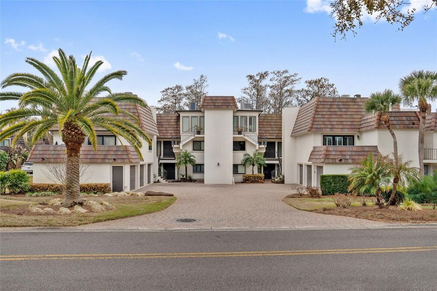 One or more photo(s) has been virtually staged. Experience waterfront luxury on the Lake Butler Chain of Lakes in this masterfully renovated residence, where contemporary elegance meets tranquil beauty. Just a short distance from iconic Arnold Palmer’s Bay Hill Club & Lodge, home to the PGA Tour’s Arnold Palmer Invitational since 1979, this three-bedroom, two-bath home is accessible via a semi-private elevator. Enter the foyer and you are welcomed with sweeping water views and absolute privacy in this open-concept interior featuring blonde hardwood flooring and a serene neutral palette. The gourmet kitchen is a chef's dream, featuring double ovens, glass tile backsplash, custom solid-wood cabinetry, elevated pantry design, sleek marble countertops, and high-end GE Profile and Sub-Zero appliances. The primary suite serves as a sanctuary, boasting a spa-inspired bath, a walk-in closet with custom storage system, and direct access to an expansive, private open-air rooftop oasis. Your private rooftop balcony is ideal for hosting events or enjoying stunning Florida sunsets over the water. Also, the ideal vantage point for nightly Disney fireworks display! Complete with a private deeded, covered boat slip and electric lift, the property is on a quiet cul-de-sac just minutes from Universal Studios, Hollywood Studios and Restaurant Row. With Orlando International Airport and downtown only 20 minutes away, and private Bay Hill membership offering world-class golf, tennis and marina amenities, this home offers an unparalleled lifestyle of convenience and prestige.