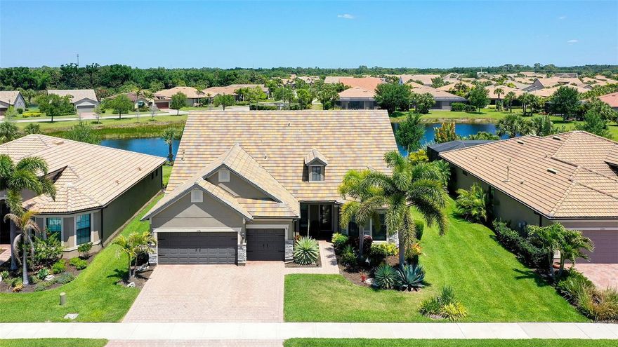 Beautifully appointed lake front home in popular Sandhill Preserve on Palmer Ranch. Over 3700 sq. ft. under air. 4 full bedrooms, 4  full baths, bonus room plus an office. Large bonus room (35x21) & a large guest bedroom (20x20). The entire house has hurricane impact windows & doors for low insurance costs. This home has approximately  $200,000 in upgrades. The entire downstairs features red wood floors, gourmet kitchen with upgraded stainless appliances. Generous first floor primary bedroom has very large walk in closet. Large extended paver brick, screened lanai(40x20) with beautiful lake views. 3 car garage with 4 ft. depth extension for extra storage.  Sandhill Preserve is one of Palmer Ranch's newer communities with only 308 homes* The community features a community pool, jacuzzi, fitness center, club house, fire pit, barefoot bar area tennis & more. Located in the heart of Palmer Ranch just minutes from world famous Siesta Key beach, shopping, restaurants & Legacy bike trail.
