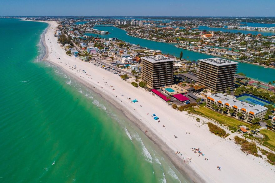 Stunning panoramic waterfront views of Sunset Beach, the Gulf of Mexico, and the Intracoastal Waterway highlight this premier 11th-floor corner residence. This rare 2 units combined offers 3 bedrooms, 3 bathrooms, 3 covered parking spaces, 2 storage closets and 2,940 sq. ft. of living space, plus 120 linear feet of wraparound balconies overlooking turquoise waters and silky sand beaches. An incredible opportunity to remodel to create your own custom beachfront residence. Mansions by the Sea is a gated community featuring resort-style amenities, including tennis/pickleball courts, a beachside heated pool, fitness center, and social clubhouse.