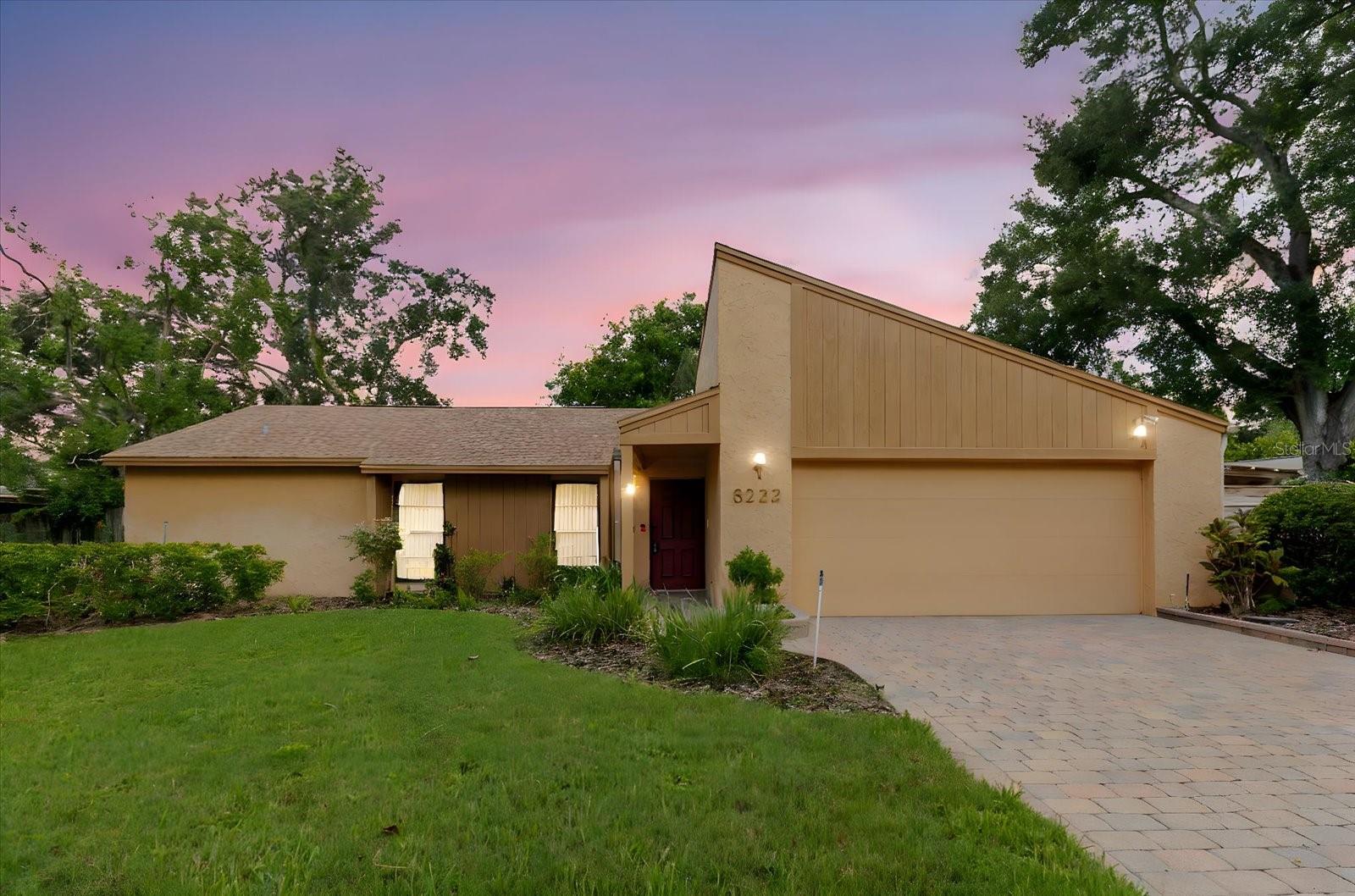 This well-maintained 4-bedroom, 2-bathroom home is set on a quiet pond in the Lago Vista community and offers a thoughtful split-bedroom layout that provides privacy and flexibility for everyone. Inside, the home features a formal living room, a separate dining area, and a centrally located kitchen that connects seamlessly to the main living spaces. A standout feature is the expanded family room, complete with a built-in radio system and a custom bar—ideal for morning coffee or evening cocktails. This inviting space opens to an enclosed patio with a fully equipped outdoor kitchen, perfect for entertaining or relaxing. Additional highlights include a 2-car garage, carport with extra storage, hurricane shutters, a fenced yard with mature landscaping, and a sprinkler system throughout the yard. Pride of ownership shows throughout. Conveniently located just 14 minutes from Tampa International Airport and close to dining, shopping, entertainment, and major roads including Dale Mabry Highway and I-275. With a low $20 annual HOA and no CDD fees, this is a rare find in a prime location. Homes like this don’t last—schedule your private showing today.