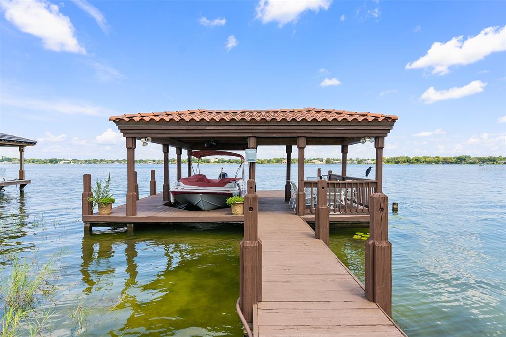 Fabulous opportunity to own one of the few lakefront homes in College Park on Interlaken facing Lake Fairview. What an amazing street with estate homes from beginning to end! This home is a 6 bedroom with 4 full baths and 2 half baths. The main living area is open and spacious and has vaulted ceilings with a glass across entire back so you take full advantage of your lake view. The pool is a resort style design with two beach entries, a spacious jacuzzi and a natural flag stone style deck! The covered patio over looking the pool and lake is spacious with plenty of room for dining and entertaining. The master bedroom is just extremely spacious with two additional areas for meditation, studying, or relaxing. Off the master is your own private balcony so you can hear the birds chirping in the morning!! The master bathroom has double sinks, granite counter tops, bidet, spacious shower with multiple shower heads and of course a full walk in closet. There is also an office, playroom or exercise room upstairs. This flex room is very large and if a 7th bedroom was needed a closet and bath could easily be added or it could be made into another master bedroom. There is a secondary master bedroom downstairs with an ensuite bathroom. There are a total of 6 bedrooms with 5 downstairs and one upstairs PLUS an additional flex office area upstairs. The downstairs bedrooms are a split plan with 3 on one side and 2 on the other. The living areas, the kitchen and dining areas of the home are completely open for easy entertaining and all have a view of the pool and lake. Imaging spending your days looking at this view! Summer is around the corner and you could be skiing those days away and enjoying your pool, large yard and beautiful dock with a terrific view. This home does offer tremendous privacy for the new owner! College Park is a wonderful community with shopping, dining and entertainment! Easy access to Winter Park, Downtown, and the MCO and executive airport. Room Feature: Linen Closet In Bath (Primary Bedroom).