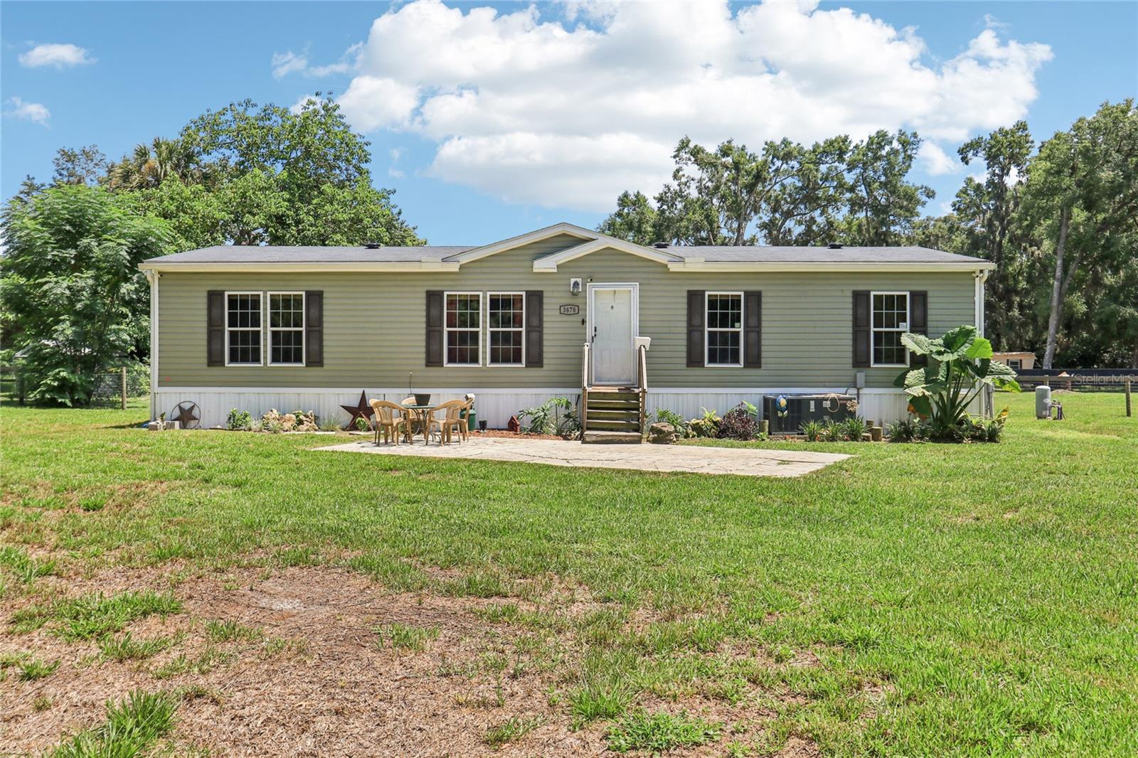 Welcome to 3878 SE 145th St in beautiful Summerfield, FL—where peaceful country living meets modern convenience. Tucked away on a spacious 1.28-acre lot with no HOA, this 2020-built home gives you the freedom to live life your way—whether that means planting a garden, raising a few chickens, parking your toys, or just enjoying wide open space under the Florida sky. Inside, you’ll find 3 spacious bedrooms and 2 beautifully appointed baths, all wrapped in 1,456 square feet of open, airy living space. The kitchen is truly the heart of the home, featuring a massive 10'x4' island perfect for family gatherings, smart lighting to set the mood, and a walk-in butler’s pantry that’ll make you feel like a gourmet chef. The owner’s suite is a private retreat with a spa-style bath, complete with a soaking tub for long, relaxing evenings and a walk-in shower to start your mornings refreshed. The home also offers modern essentials like central air, high-speed internet, and low-maintenance vinyl siding, along with a well and septic system for extra independence. Best of all, you’re just a short drive from The Villages, so you’ll enjoy the best of both worlds—quiet, rural charm with shopping, dining, entertainment, and medical services just minutes away. If you’re dreaming of a fresh start with space to breathe and room to grow, this property checks every box