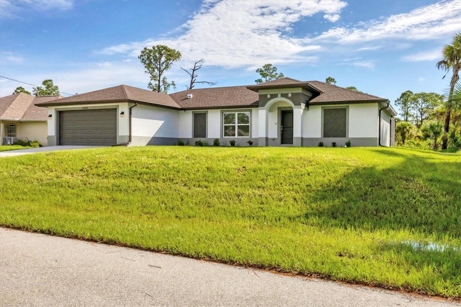 Welcome to this brand-new, move-in ready, three-bedroom, two-bath, custom pool home, nestled on a private 1/4-acre lot located on a beautiful street in North Port! Completed in September 2024, this meticulously designed residence showcases comfort and craftsmanship, featuring a host of beautiful finishes and peace of mind with a transferable warranty. As you enter, you'll be greeted by an open-concept great room centered around a stunning built-in electric fireplace, setting a warm and welcoming tone for the home. Refined wainscoting and crown molding throughout provide a sense of modern comfort. The heart of this home is the beautiful gourmet kitchen, perfect for entertaining. It features custom shaker cabinets, quartz countertops, a large center island with custom navy blue cabinetry, stainless steel appliances, a complementary tile backsplash and a spacious walk-in pantry with wood shelving for ample food storage. Adjacent to the kitchen, the dining area and breakfast bar provide plenty of seating for family and friends to gather and enjoy meals together. The private primary bedroom is thoughtfully separated from the additional two bedrooms, offering true privacy. The primary en-suite bath features custom navy blue cabinetry, quartz countertops, dual sinks and a lovely shower, your perfect retreat for unwinding. The two additional bedrooms share a beautifully designed bath with a tiled shower/tub and quartz vanity. A dedicated inside laundry room with a utility sink adds practicality to everyday living. Step outside to the lanai and pool, ideal for outdoor living and entertaining. The pool, featuring a sun shelf and ambient lighting, creates a magical atmosphere in the evenings, perfect for hosting gatherings, barbecues, or simply enjoying the Florida sunshine. This home is within walking distance to Lamarque Elementary School and offers easy access to Tamiami Trail and I-75. Enjoy great shopping and dining options in North Port and Wellen Park. Spend a day at the North Port Aquatic Center, a family-fun water park, or catch a game at the Atlanta Braves stadium in Wellen Park! Plus, the best of the Gulf Coast - golf courses, fishing, boating and stunning beaches - are all within a 25-minute drive. And the best part? No HOA or CDD fees! This home truly embodies the Florida lifestyle in every way. Don't miss your opportunity - schedule a showing today!