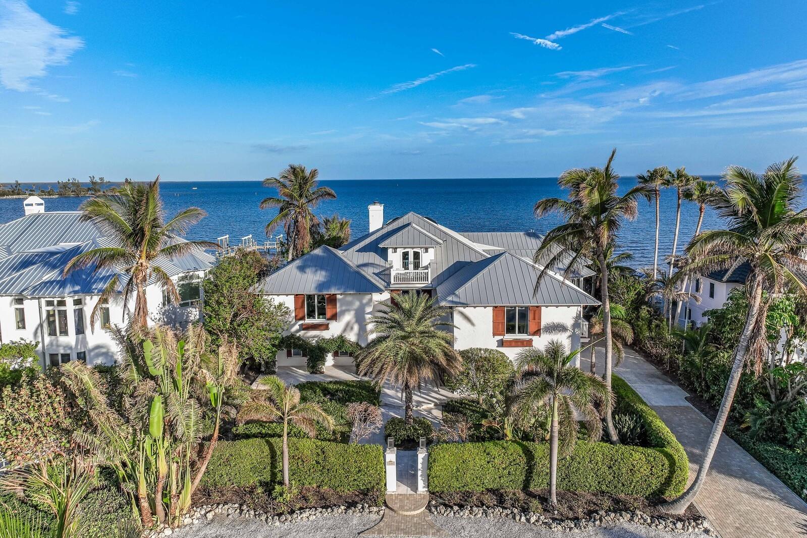 Welcome to your island paradise on Boca Grande Isles. With 100 feet of waterfront and direct access to the Intracoastal Waterway, this stunning modern take on West Indies architecture residence has been completely renovated and offers an island sanctuary. Key features to this four bedroom, five and one-half bath residence spans 4,900+ square feet of meticulously updated living with unparalleled sophistication. The spectacular great-room is a masterpiece, boasting a wood beam ceiling, porcelain tile and wood flooring, crown molding with intricate detailing, built-in bar area with wine cooler, a decorative fire-place, and an expansive wall of glass overlooking Gasparilla sound offering an abundance of natural light. This cozy serene space connects by a wall of expansive sliding glass doors to an open-air porch with breathtaking water views. This home is crafted with the finest materials and finishes, seamlessly blending modern elegance with durability. The open-concept kitchen and breakfast area create a versatile floor plan perfect for daily living. The gourmet kitchen features quartz countertops, soft-close cabinets and drawers, Bosch appliances, 6-burner gas range located on the center island, and a Sub-Zero cabinet-faced refrigerator. The expansive primary suite, on the main living level, serves as a luxurious escape, featuring a sprawling walk-in closet and a spa-like bathroom with high-end finishes, dual vanities, a soaking tub, and an oversized shower. The upper level offers three additional bedrooms, each offering its own unique charm and character. Outside, embraces the epitome of island living. Beautiful mature landscaping, a two-car garage, a captivating pool, and a cozy fire pit create an idyllic haven for relaxation under starlit skies. With deep sailboat water access, and a 16k lb boat lift, nest in this beautiful island waterside home.