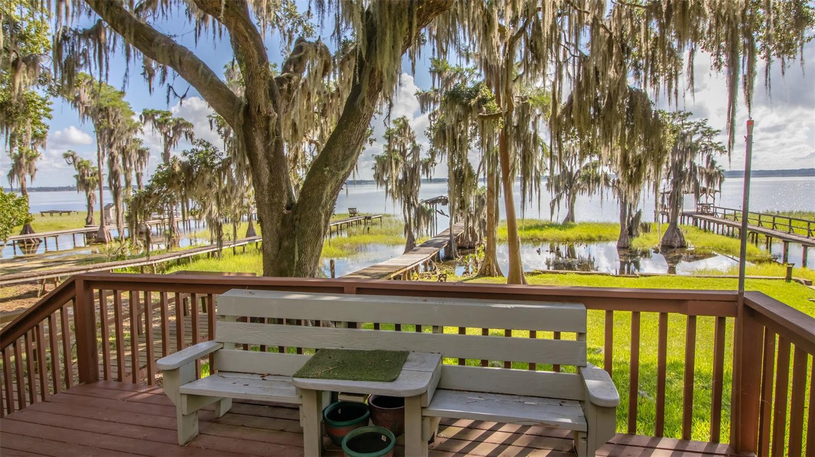 Rare Opportunity on Big Lake Santa Fe! Lovingly cared for by the same family for over 60 years, this charming lakefront retreat offers the perfect blend of history, comfort, and modern updates. Nestled on the prestigious Big Lake Santa Fe, this 2-bedroom, 2-bath home spans 1,512 sq ft all on one level, making it ideal for year-round living or a relaxing weekend getaway. Step inside to discover a thoughtfully renovated interior with upgraded electric, plumbing, kitchen, bathrooms, and a durable metal roof for peace of mind. The spacious primary suite features a large walk-in closet and private ensuite bath. Outside, you'll find beautifully mature landscaping, a carport, a storage shed, and a large workshop with its own covered parking area—perfect for hobbies or additional storage. But the crown jewel is the waterfront: enjoy your mornings and evenings on the private dock, relax under the covered gazebo, or take full advantage of the boathouse for all your lake toys. With deep water access, this lake is a dream for fishing, swimming, and boating right from your own front yard.
Don't miss your chance to own a piece of paradise on one of North Florida's most sought-after lakes!