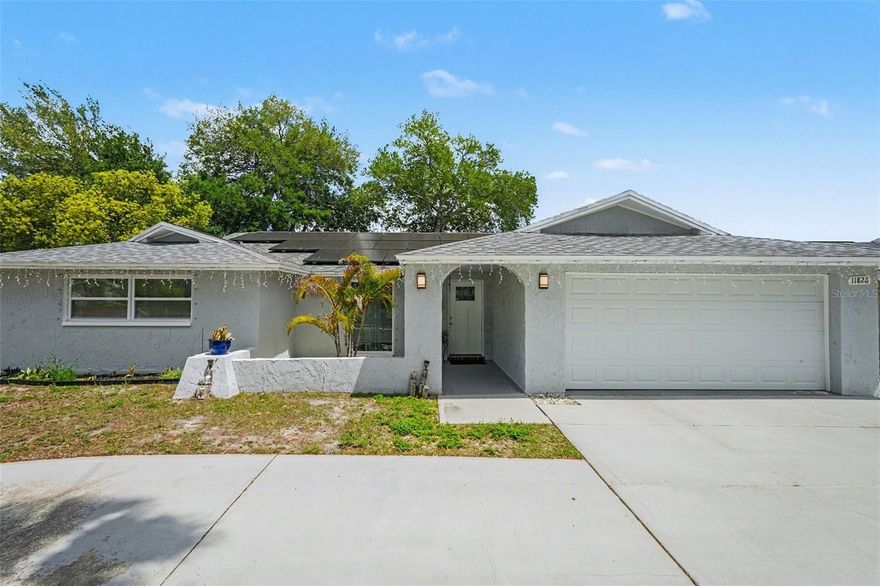 Stop searching for 'new' and step into this meticulously reimagined 4-bedroom, 3-bathroom sanctuary where every high-ticket detail has been handled for your total peace of mind. This stunning corner-lot residence offers nearly 2,000 sq. ft. of carpet-free, open-concept living, featuring a brand-new roof (2020), HVAC (2020), and all-new windows and doors (2021) that complement the fresh, modern aesthetic. The chef-inspired kitchen—complete with sleek quartz countertops and stainless steel appliances—serves as the heart of the home, offering views of your massive, screened-in pool which features a brand-new pump and filter (2025). Designed for both style and freedom, this property boasts a sprawling circular driveway, corner lot with abundant parking for guests, boats, or toys, all-tile flooring, and modern designer finishes in every bathroom, all while being situated in a preferred No-Flood Zone with no HOA or CDD fees. Perfectly positioned just minutes from the vital US-19 and SR-52 corridors, you’ll enjoy rapid access to the best shopping and dining in Port Richey while tucked away in your own private oasis—this is the turn-key opportunity you’ve been waiting for, so schedule your private tour today before it’s gone."