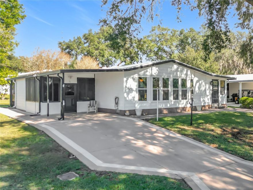 New Price Reduction! – Priced to Sell! – Whether you're hosting a large gathering or casual get together you'll enjoy the Energy Efficiency, Comfort, and Versatility of this Delightful Move-In-Ready Turnkey 2/2 with Carport and Covered Golf Cart Parking located in the Heart of the Desirable Orange Blossom Gardens, The Villages. This lovely home comes complete with Existing Furniture and New King Size Bed Set, NEW HVAC (2025), Roof (2018). The Open Floor Plan, Gourmet Kitchen and Fully Air Conditioned Enclosed Florida Room is designed to accommodate every occasion. Large Living & Dining Room area with Bay Style windows and Double pane Thermo-Insulated Tilt-in Windows. Enjoy your favorite music throughout the house through the built-in hard-wired stereo system. Spacious Primary Bedroom & Guest Bedroom, Updated Primary Bathroom features a Tile Walk-in-Shower and Guest Bathroom with Tub/Shower, freshly painted, updated lighting, faucets and hardware. Laundry area is nicely sized with washer, dryer and lots of storage area. The Enclosed Sunporch off the carport is especially convenient for loading/unloading before entering the home's foyer. There's also a separate covered golf cart parking area at the rear of the property. Just minutes from SPANISH SPRINGS TOWN SQUARE, POOLS, RECREATION CENTERS & WORLD-CLASS AMENITIES — Golf, Pickleball, Tennis, Social Clubs, and Nightly Entertainment. Call your Realtor to schedule your showing today!