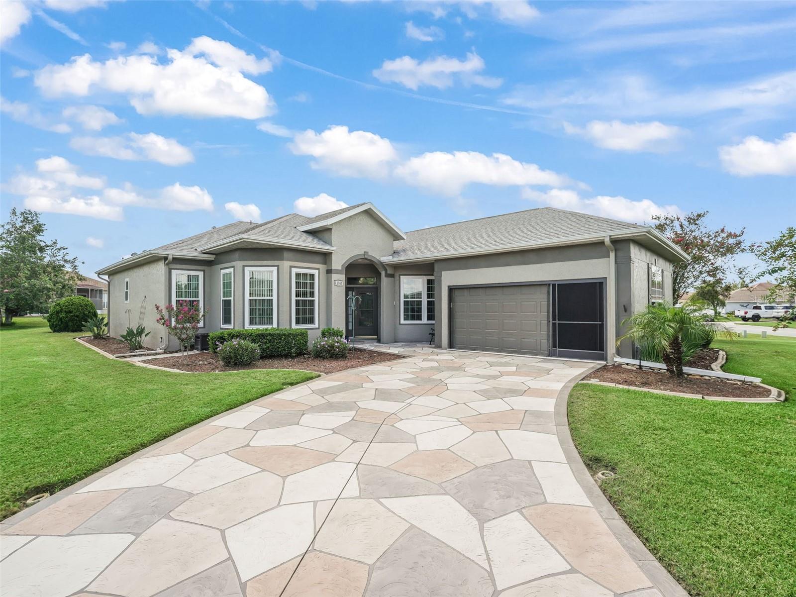Stonecrest is a 55+ gated golf course community with all the amenities and 4 pools (one indoor), and just a Bridge Away By Golf Cart To The Villages! Stunning 3/2 Monticello on an Oversized Corner Lot with a 2 Car Garage, Room for a Pool, and Tremendous curb appeal featuring Designer Stamped Concrete Driveway & Walkway (May 2020), Meticulous Professional Landscaping, Gorgeous Exterior Rhino Shield paint (2023 with a 25 year warranty), and Covered Entrance with Storm door. You will love the Open Concept Floor Plan with 1723 sq ft of Living Space, with 1483 under Heat and Air. This Spacious, Light and Bright home is just perfect for Entertaining Friends and Family! This well appointed home boasts Soaring 10 ft ceilings, Crown molding, French doors, and newer Interior paint (2023)! The Large Kitchen features Granite countertops, Tile backsplash, White Wood cabinetry, Stainless Appliances (refrigerator December 2023), Pantry closet, a generous breakfast bar, and an Eat -In area! The Dining Area (currently used as a sitting area) flows to the Spacious Living area with sliding door access to the Glass Enclosed Lanai. The Luxurious Primary Suite showcases a Private Entry to the Lanai, a nice size Walk in Closet and En Suite Bathroom, featuring a newer one piece Commode (2024), 2 Granite topped Vanities (Jan 2023), Linen Closet, and a Striking Tiled Walk in Shower. The 2nd bedroom features a nice size built in closet, while bedroom 3 (no closet) offers an elegant French door entry, Built-In Murphy bed, and can be used as an office or den. The Guest bathroom features a Granite topped Vanity (Jan 2023), newer one piece Commode (2024), and a Tiled Tub & Shower combination, offering your guests plenty of Space, Convenience, and Privacy! Vacation at home, on the 17 x 15 Glass Enclosed Lanai with Stunning Wood Look Tile flooring, and access to the Birdcage covered Paver Patio featuring a Gazebo with Sunshades (March 2023), peaceful Gardens, and Rear Privacy Landscape! Enjoy Sunset Dinners & Cocktails, Tropical breezes, and Fabulous BBQ's, all in your own Private Oasis! The nice size 2 Car Garage is freshly painted (March 2025), and offers Screen doors (2019). Enjoy peace of mind with the Termite treatment (May 2025), New thermostat (May 2025), 5 Windows Replaced (May 2024), Roof cleaned (Dec 2024), Hot Water Heater (Feb 2021), Dryer (2020), Carpet (2019), ROOF (2018), HVAC (2018).
If you are looking for a Well-Designed home with a Fantastic Open Concept Floor Plan, and an Exceptional Outdoor Living space, then this is the Home for You! Stonecrest is a 55+ gated golf course community with all the amenities, pools, pickleball courts, softball, 18 hole championship golf course, Broad Stripes Golf & Social Club and over 80 different clubs to join! Stonecrest is just a bridge away by golf cart to the Villages. It is a community with Private Roads and 24 Hour Security! As a private gated golf course community, you can expect a high level of privacy and security. Overall, this home offers a combination of Tremendous Outdoor Space, luxurious features, a desirable location, and a secure community setting. A WONDERFUL LIFESTYLE AWAITS YOU IN STONECREST!