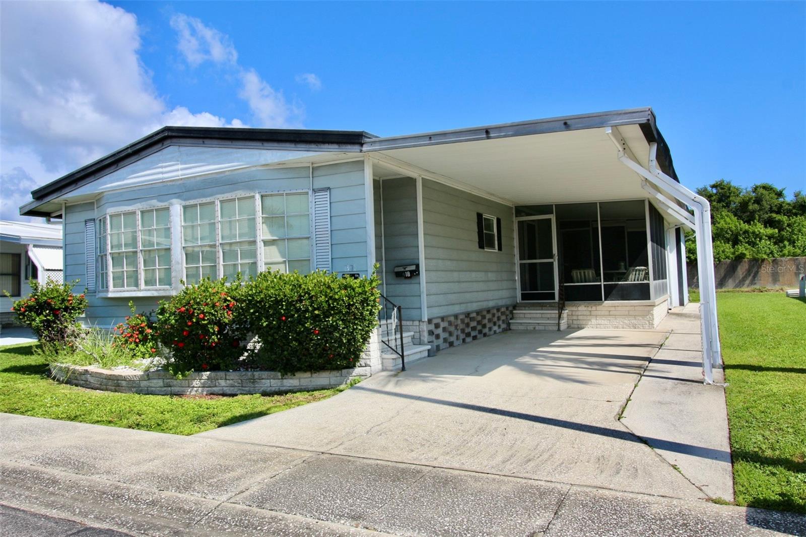 Under contract-accepting backup offers. **GOLDEN GATE SPECIAL! RESIDENT OWNED COMMUNITY** BRAND NEW COMFORTMAKER AC SYSTEM (2025) AND WATER HEATER (2025)!! Spacious fully furnished 2-bedroom, 2 full baths with over 1300 heated square feet of living area. Open floorplan, large enough to entertain all of your family and friends. Enormous primary bedroom with ensuite private bath, low step in shower with two seats and grab bars. Gigantic walk-in closet and ceiling fan. Second bedroom has a full-size closet and private access to guest bathroom. Guest bath has a tub/shower combo and grab bars. Awesome family room with a wet bar and soaring cathedral ceiling. Dining room has a beautiful built-in China cabinet with glass display. Decorative archways and ceiling fans throughout. Home offers a separate room with endless possibilities. Owner currently uses the room for an office; buyer could convert back to a huge interior laundry room. Nice screened outdoor living area. Owner added concrete strip along carport for his scooter and also has a covered scooter garage that could be converted for future golf cart. Large outside laundry/workshop room with lots of storage and shelf space. Metal outside exterior and roof over. High and dry flood zone X, home had no damage from last year hurricanes. Backyard is surrounded with natural privacy overlooking tranquil freshwater canal revealing Florida's majestic birds and wildlife. Wonderful opportunity to be the new owner in one of Pinellas Counties Elite 55+ active resident owned communities with a low monthly fee of only $210.00! Tropical Florida Lifestyle Living offering a sparkling heated in ground pool, heated spa, shuffleboard courts, horseshoe pits, bocce ball court, clubhouse, billiard room and endless scheduled activities. Easy access to Tampa, St. Petersburg, all major highways, interstates and Our World-Famous Sugar Sand Beaches! Cash only. Call and schedule your private showing and make this your Florida home today!