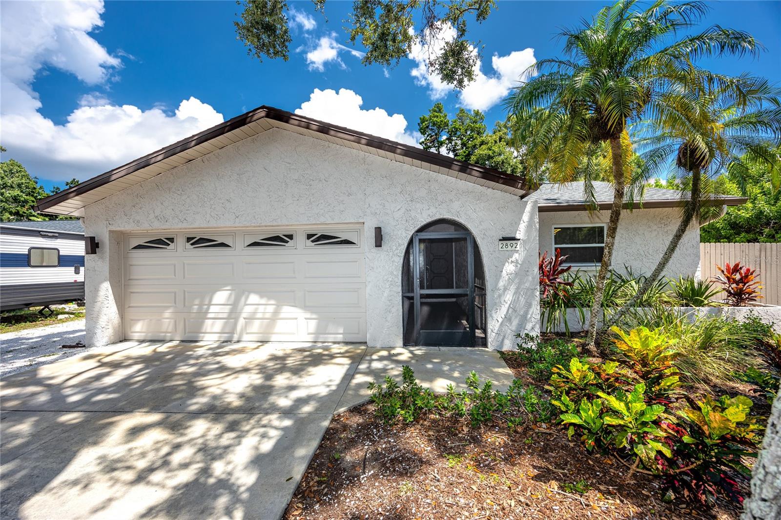Step into turnkey Florida living with this beautifully remodeled Clearwater pool home, ideally situated on a spacious, fully fenced corner lot. Offering three bedrooms, two bathrooms, and a host of high-value upgrades, this property is equally suited for homeowners seeking a private oasis or investors looking for a ready-to-rent short-term rental opportunity. With no HOA and no short-term rental restrictions, it’s a rare find that combines lifestyle and flexibility.
Inside, you’ll find a thoughtfully updated floor plan that blends comfort and function. The living room, dining area, and kitchen flow seamlessly together, creating the perfect setting for both daily living and entertaining. A complete kitchen remodel in 2023 introduced modern cabinetry, sleek countertops, and quality appliances, while both bathrooms were also refreshed with contemporary finishes. Fresh interior paint and luxury vinyl plank flooring add to the bright, modern feel.
The primary suite features a spacious walk-in closet and private en-suite with dressing area, while two additional bedrooms are tucked on the opposite side of the home in a split-plan layout. Peace of mind comes with major system updates, including a new roof (2022), updated electrical panel (2023), newer AC system (2021), and pool pump replacement (2024).
Outdoor living takes center stage here. A large screened lanai connects directly to the heart of the home with wide sliders, opening to a heated pool and spa, outdoor bar, and expansive deck space—perfect for year-round entertaining. The oversized driveway and dedicated parking for a boat or RV make this property even more versatile.
All of this comes in a prime Clearwater location, just minutes from US 19, Courtney Campbell Causeway, and Gandy Bridge, offering quick access to Tampa International Airport, vibrant downtown St. Petersburg, and the award-winning sands of Clearwater Beach. Everyday conveniences like Costco, Sam’s Club, and Target are right around the corner.
Whether you’re searching for your forever Florida home or an investment with strong income potential, this move-in-ready Clearwater pool home delivers unmatched value and flexibility.