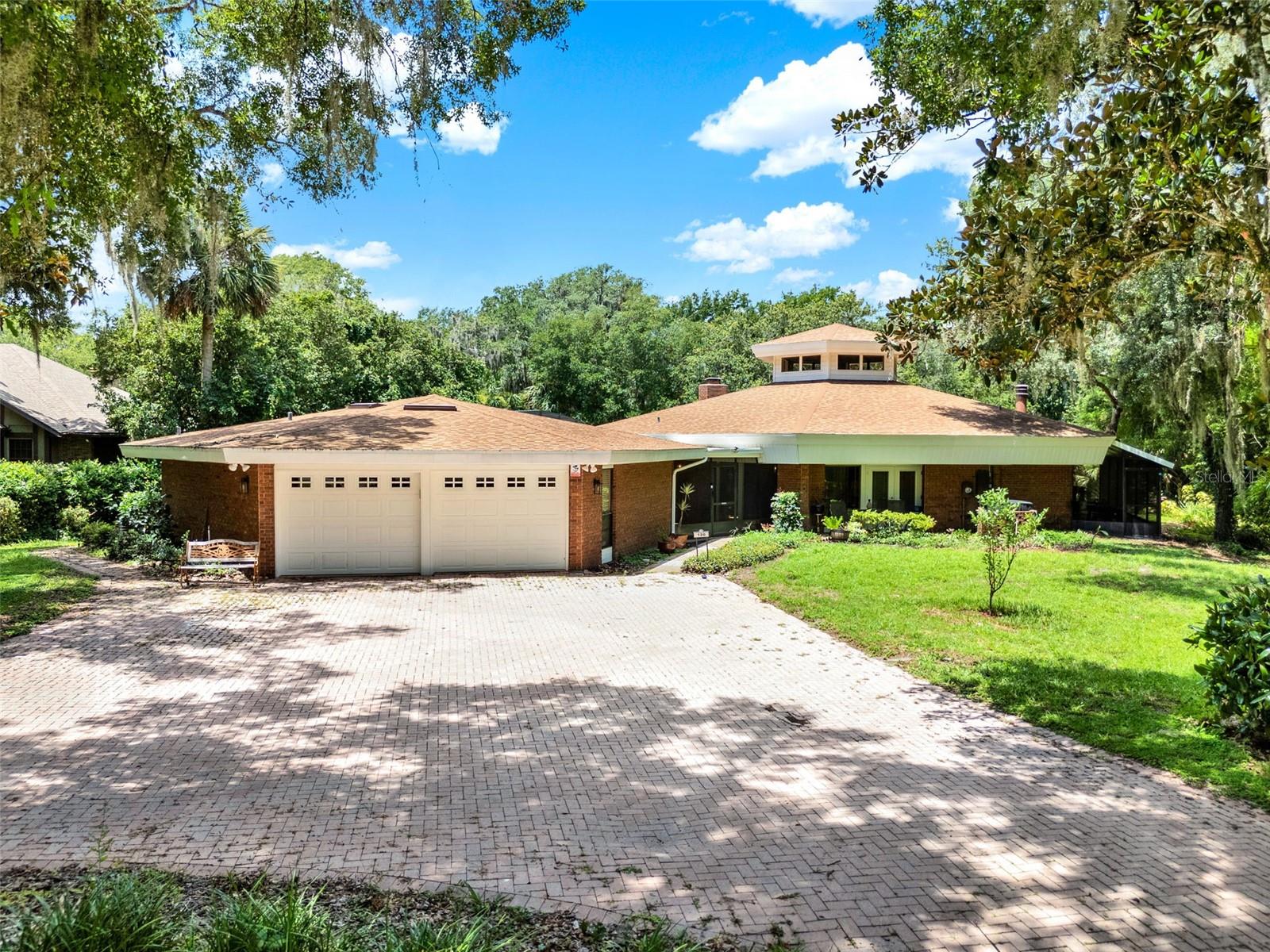 Experience Riverfront Serenity in This One-of-a-Kind Florida Oasis! Welcome to 120 River Oaks Circle, an extraordinary 3-bedroom, 3-bathroom waterfront pool home nestled on a private 1.35-acre sanctuary along the scenic Wekiva River. Surrounded by lush greenery, this unique estate offers the perfect blend of privacy, comfort, and immersive natural beauty—ideal for nature lovers, kayakers, bird watchers, and anyone seeking a tranquil, outdoor-oriented lifestyle. Designed for those who cherish the outdoors, this property offers unparalleled views of the river and pool from nearly every room. A sprawling screened-in lanai wraps around the entire back of the home, creating multiple areas to relax, dine, and entertain—all with panoramic views of the river and the beautifully landscaped backyard. Step outside and experience your own private nature preserve. The gently sloping backyard is framed by mature trees, providing natural privacy and direct access to the river. Imagine cozy evenings around a fire pit under the stars, gardening in your private raised garden, launching your kayak from the cedar dock, or simply relaxing in a hammock by the water. The Wekiva River, a protected and vibrant ecosystem, offers endless wildlife viewing opportunities—spot otters, turtles, bald eagles, tortoises, and even the occasional Florida black bear. This thoughtfully designed residence is composed of two octagonal structures connected by a covered breezeway—creating a sense of architectural whimsy and function. The main home features an open-concept layout that circles around a stunning central kitchen topped with a dramatic cupola ceiling. The main living area includes the living room, dining area, laundry room, two bedrooms, and two full bathrooms, including the spacious primary suite, which boasts a private fireplace, French doors opening to the riverfront, and even an in-room hot tub. Throughout the home, you’ll find exposed wood beam ceilings, rich wood flooring, interior brick accents, and expansive windows that seamlessly connect indoor and outdoor living. The updated kitchen is a showstopper with solid wood cabinetry, granite countertops, and gunmetal grey appliances. The second building includes an oversized two-car garage and a private in-law suite, complete with its own bedroom, full bathroom, and French doors that open directly to the pool and river views—ideal for guests, multigenerational living, or a home office. The screened-in pool and outdoor living area are perfect for Florida living. Enjoy three distinct seating areas, a full outdoor kitchen and bar, poolside dining spaces, and plenty of room for lounging and entertaining. This home has been lovingly maintained and thoughtfully upgraded by the current owner. Recent improvements include: Roof (2019), Exterior and Interior Paint (2024), Kitchen Appliances (2024), Water Heater in In-Law Suite (2024), Skylights (2024), Cedar Dock (2024), Water Softener (2022), Garbage Disposal (2023), Well (3-4 years old). Hook up for Whole House Generator (50-amp exterior plug). Whether you're seeking an artist’s retreat, a home that embraces eco-living, or a forever home with unmatched charm and serenity, this property delivers a once-in-a-lifetime opportunity to own a slice of untouched Florida paradise. From sunset paddles on the river to quiet mornings listening to the birds, every moment here is magical. Don’t miss your chance to experience this unforgettable riverside escape!