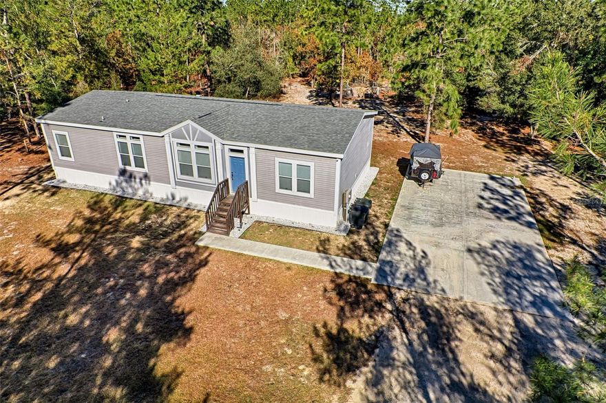 Welcome to Your Slice of Country Paradise at Melrose Landing!  Discover the perfect mix of modern comfort and peaceful rural living in this beautifully maintained 3-bedroom, 2-bath Palm Harbor home, just 3 years young. Nestled on a serene 2-acre lot, this spacious 1,800 sq. ft. is move in ready. Step inside to an inviting open-concept layout featuring luxury vinyl plank flooring throughout the main living spaces. The oversized living and dining areas are perfect for entertaining or nights in.  At the heart of the home, the kitchen steals the show with a center island, stainless steel appliances, upgraded lighting, plenty of cabinetry and generous counter space. Enjoy views from the large kitchen sink window overlooking your backyard oasis. The primary suite is a private retreat, complete with a spa-like ensuite bath featuring dual sinks, a makeup vanity, walk-in shower, private toilet, and a huge walk-in closet. Two additional bedrooms, both with walk-in closets and a full guest bath provide comfort and flexibility for family or guests. Convenience continues in the well-equipped laundry room with built-in storage, countertop space and direct outdoor access—perfect for muddy boots or gardening days. Outside, you’ll find: Oversized parking pad ready for your future garage or workshop.  Storage shed for tools, toys, or hobbies.  Fenced garden area to grow your own vegetables or flowers.  Energy efficiency with Clay Electric service and a Honeywell smart thermostat Located just a short drive from Gainesville, Melrose, Interlachen and Hawthorne, you’ll enjoy country living without sacrificing access to shopping, dining, and services.