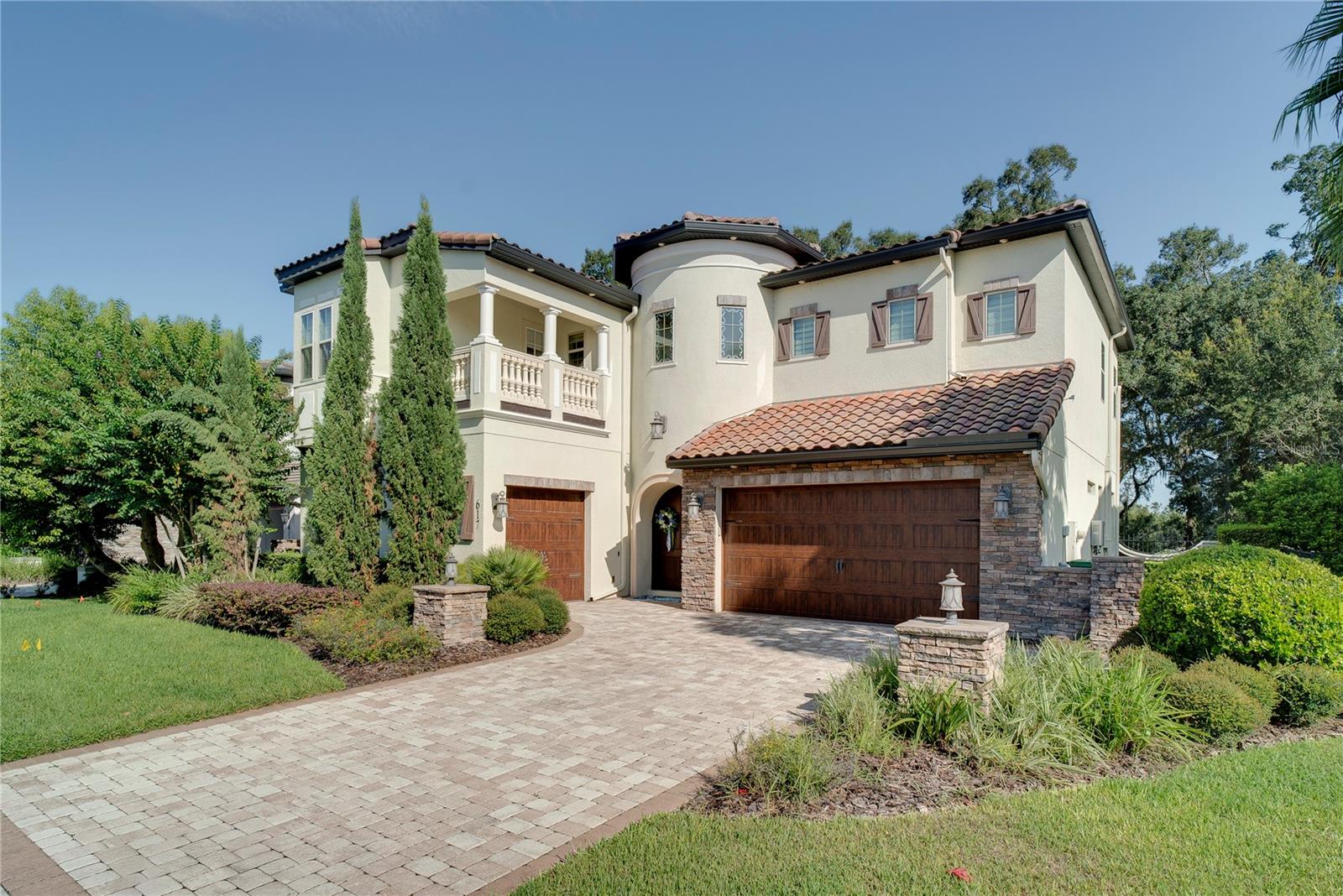 They say location is everything—and this home delivers. The Sanibel (affectionately called The Castle) puts you right where you want to be. Tucked just minutes from Winter Garden and the charm of Historic Downtown, this award-winning residence blends timeless Italian architecture with modern comforts—where luxury meets functionality and convenience.
From the moment you arrive, the home makes a statement with its arched wood double doors, custom soffit lighting, and classic concrete tile roof. Inside, soaring ceilings, intricate beams, and crown molding create a sense of grandeur, while an open floor plan makes the home ideal for both daily living and entertaining.
The gourmet kitchen is a chef’s dream with KitchenAid appliances, a natural gas cooktop, built-in refrigerator, 42" custom cabinetry, a hidden walk-in pantry, and a reverse osmosis water system. A Junior Owner’s Suite and private office on the first floor add flexibility, while upstairs the primary suite becomes your sanctuary—complete with a round spa-like bathroom, oversized walk-in closet, wet bar, and balcony access. Two additional en-suite bedrooms, a loft, and laundry complete the second level.
Outdoor spaces invite you to unwind or entertain with Trex-decked balconies, a summer kitchen, and a tranquil fountain. Added comforts include surround sound wiring, a whole-home generator, and thoughtful upgrades throughout.
Beyond the home itself, the location is second to none. You’re just minutes from Downtown Winter Garden’s lively restaurants, boutiques, and farmers market, as well as top-rated schools, beautiful parks, and convenient access to major highways.
Recognized as Florida’s Best Model Home by the SEBC Excel Awards, The Sanibel combines a prime Winter Garden address with architectural distinction, luxury, and a lifestyle built on convenience.