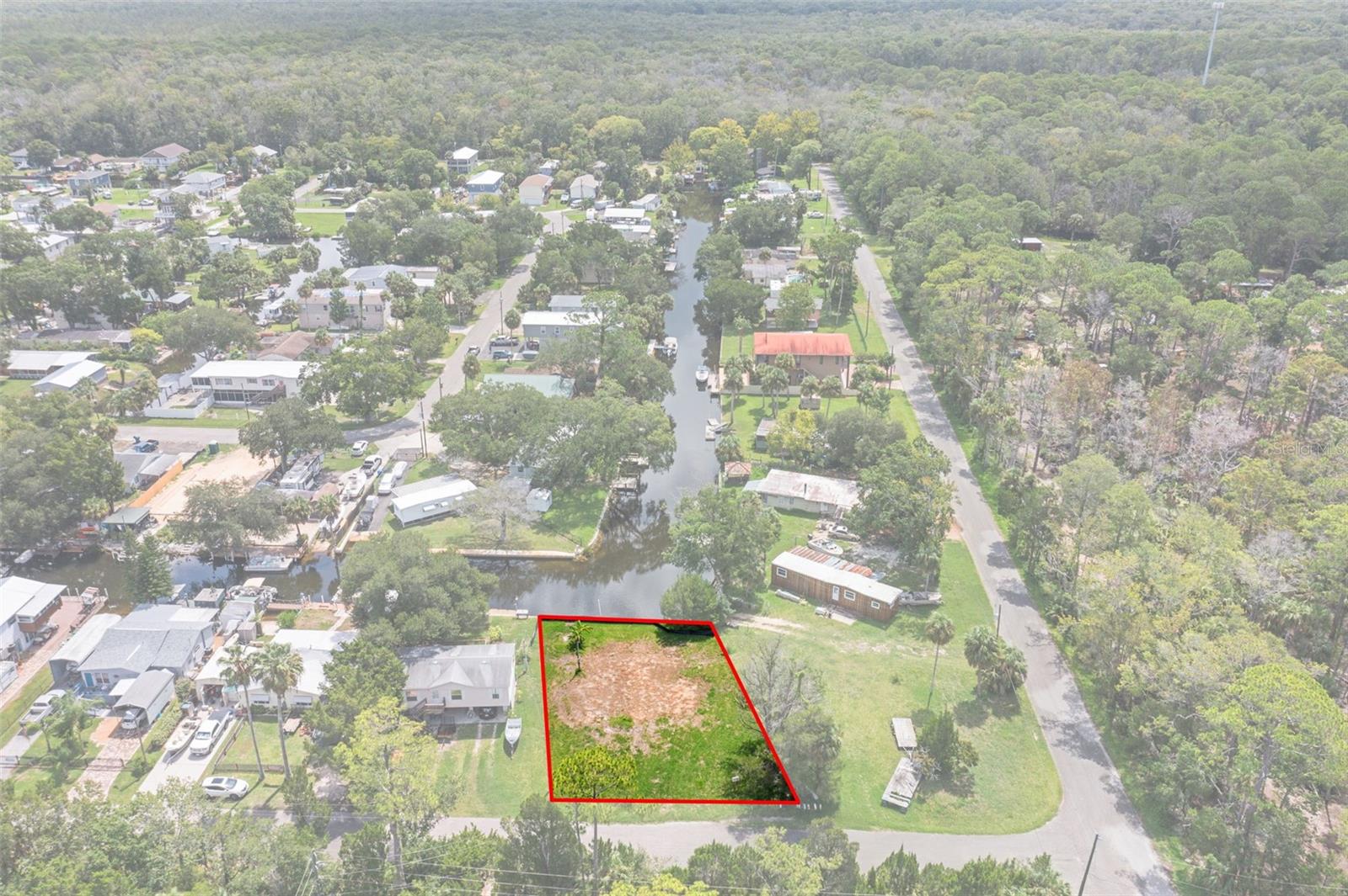 Discover the perfect opportunity to own a true waterfront retreat in the highly sought-after Palm Grove Colony! Nestled among mature trees on a spacious lot with 60 feet of seawall frontage, this serene canal-front property offers direct access to the crystal-clear Weeki Wachee River and direct Gulf access via the Mud River. Ideal for fishermen, boaters, and kayakers alike, this peaceful neighborhood provides a front-row seat to Florida's natural beauty—watch fish jump and manatees glide by from your own backyard with the best water views on the canal because you do not look directly across at any neighboring homes. Water, electric and sewer hookups are present. Don't miss your chance to embrace the tranquil lifestyle of this hidden gem!