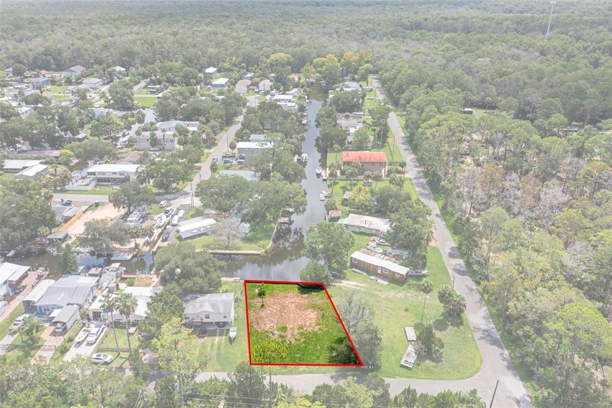 Discover the perfect opportunity to own a true waterfront retreat in the highly sought-after Palm Grove Colony! Nestled among mature trees on a spacious lot with 60 feet of seawall frontage, this serene canal-front property offers direct access to the crystal-clear Weeki Wachee River and direct  Gulf access via the Mud River. Ideal for fishermen, boaters, and kayakers alike, this peaceful neighborhood provides a front-row seat to Florida's natural beauty—watch fish jump and manatees glide by from your own backyard with the best water views on the canal because you do not look directly across at any neighboring homes. Water, electric and sewer hookups are present.  Don't miss your chance to embrace the tranquil lifestyle of this hidden gem!