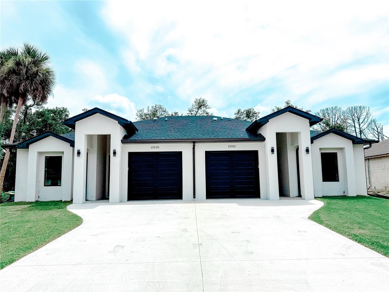 Introducing a newly constructed duplex, featuring an extra-wide driveway, a covered
lanai, and impact-resistant windows. The property is serviced by city water and boasts vaulted ceilings in the
living room, as well as a generously sized garage offering additional storage space. With numerous premium
features throughout, this property presents an exceptional opportunity. Schedule your showing today!