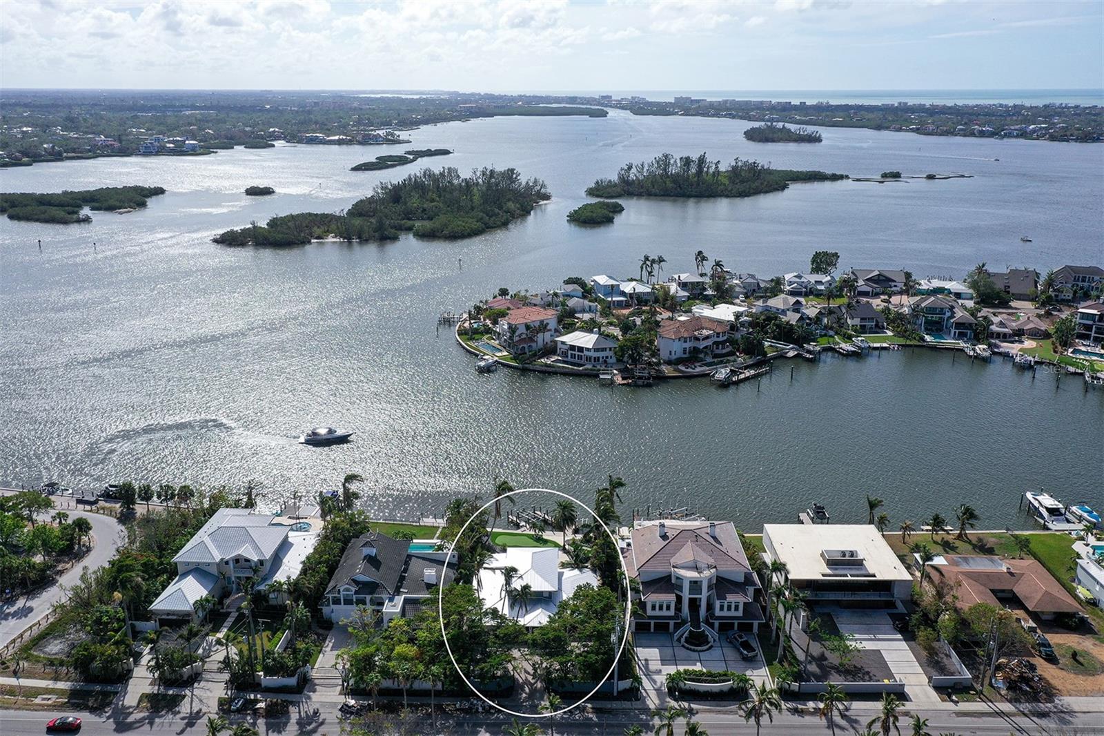 Now is the perfect opportunity to build your dream home or renovate on the highly sought-after north end of Siesta Key! This prime property boasts wide, breathtaking water views and deep-water access, ideal for boating enthusiasts. The expansive lot spans over 1/3 acre, offering ample space to create a custom retreat. Currently, the first floor of the home needs renovation, as it took on water from recent storms. The second floor, however, remains unaffected. Although being sold for land value, buyers have the option to renovate the existing structure. Inside, the home features an open floor plan with a wall of glass sliders that stretch the length of the home and showcase the stunning water views and seamlessly connect indoor and outdoor spaces. The main level includes three spacious bedrooms, each with its own ensuite bathroom for maximum convenience and privacy and washer dryer hookups. The second floor offers a large private master suite with a walk-in closet, washer and dryer, dual sinks, soaking tub and beautiful walk-in shower. Off the bedroom is a spacious balcony, perfect for enjoying morning coffee while taking in the expansive bay views. The home is gated with a paver courtyard, beautifully landscaped and includes an outdoor kitchen and entertainment bar off the inviting pool. Crafted for boating aficionados, the home features two docks/lifts—one rated for a 20,000 lb boat and the other for your run-about bay boat. For serious boaters seeking wide, deep waters and quick access to the Gulf of Mexico, this is the perfect place to call home. Enjoy the ultimate combination of location and convenience, with easy access off the island and just moments from the beach. Don’t miss out on this rare chance to own a prime piece of Siesta Key paradise!