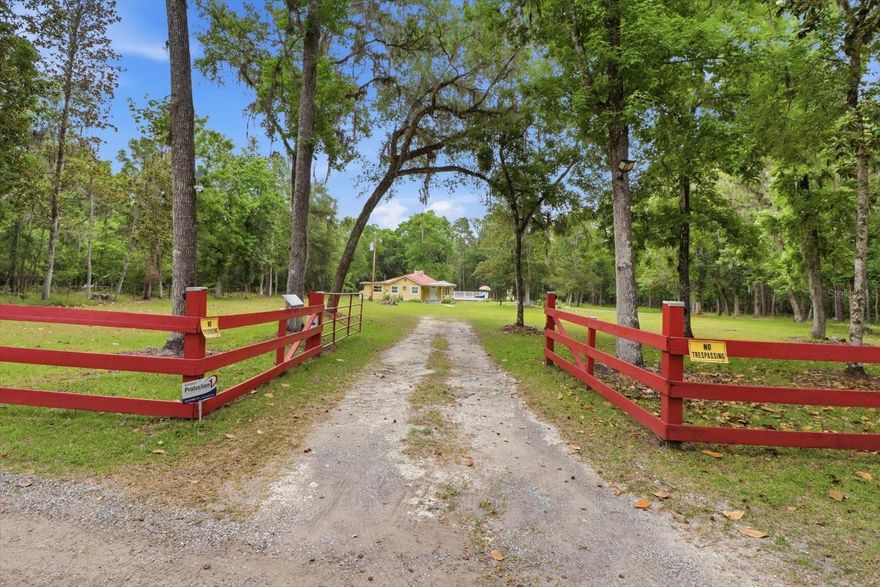 One or more photo(s) has been virtually staged. What a unique opportunity to own a homestead with the perfect blend of privacy, natural beauty, convenience and the ability to be self-sustaining, with this move in ready, super comfortable 2BR/1BA single family home on 4.80 acres at the end of a quiet, paved road in Brooksville, Florida. Enjoy exceptional seclusion with two sides of the property — to the north and east — bordering a vast conservation area (Chinsegut) filled with trails to explore.  Property is zoned AR, allowing for livestock as well.
This 1,246 sq ft home has been thoughtfully updated throughout, including a brand-new home foundation and brand-new subfloor, both completed by licensed professionals and backed by transferable warranties. Inside, new laminate flooring and deluxe baseboards create a clean, modern finish that pairs beautifully with the fully renovated bathroom, electrical updates, and the cozy wood burning fireplace with a stone mantel, hearth and chimney.
Outdoor living shines here with a new 36' x 28' composite deck featuring a built in 8.5' x 12.5' spa with secure railing — perfect for entertaining or unwinding under the stars. A 12' x 24' shed with electricity and water offers ideal space for storage, hobbies, or workshop use. The property is fully fenced with motion sensor and solar lighting throughout.
The 4.80 acres are mostly cleared and dotted with oak, pine, and cedar trees, along with an impressive variety of fruit trees including orange, fig, papaya, peach, persimmon, olive, Meyer lemon, guava, cherry, and yucca. Wildlife sightings are common, adding to the peaceful, natural setting.
The sale includes all kitchen appliances, featuring a brand-new large side by side refrigerator, plus a washer, dryer, and water softener. Additional recent upgrades include a 2021 tin roof, new gutters, four mini split AC units (installed 2021) with room to add another unit, a one-year-old well, and a septic system inspected in the last three (3) months. A new automatic entrance gate opener has also been added.
Seller is open to negotiating the purchase of lawn/property equipment, if desired. Located less than six miles from major conveniences, this property offers a rare opportunity to enjoy peaceful country living while staying just minutes from everyday essentials.
Come see this gem before it is gone!!