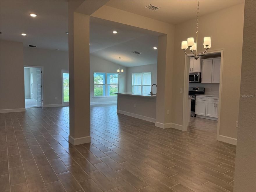Introducing a move-in-ready and exceptionally spacious residence! Discover the epitome of living well in this exquisite 1970 Sq ft home, boasting 3 bedrooms, 2 baths, a 2-car garage, and an abundance of entertainment space. Unparalleled attention to detail awaits you throughout this masterpiece. As you step inside, you'll be greeted by the captivating open-concept great room, dining room, and kitchen, adorned with 10' ceilings, enhancing the grandeur of the space. Revel in the elegance of wood-look ceramic plank tile flooring in the main areas, complemented by the timeless allure of quartz countertops in the kitchen. Every inch of this home has been carefully designed with your comfort in mind. The lavish owner's suite offers a generous layout, while the ensuite bathroom boasts a double sink vanity with additional storage drawers, a linen closet, and a relaxing garden tub, among other luxurious features. Two additional bedrooms share an oversized bath with a linen closet, tub-shower combo, separate toilet, and a single vanity with ample storage. Located within a pet-friendly, gated community and connected to city water and sewer, this property presents a truly desirable lifestyle. Notably, there are no CDD fees, and the low annual HOA fees. Beyond the bounds of this remarkable home, the surrounding area offers a wealth of amenities. North Port schools provide excellent educational opportunities for residents. Nearby, you'll find an array of shopping options, diverse restaurants, and exciting entertainment venues, ensuring there's always something to enjoy. Don't miss the chance to experience this captivating home firsthand. While this home is in pre-costruction status, a $1000 deposit will get you under contract and allow you to choose your colors AND the builder pays the majority of your closing costs when you work with one of our preferred lenders! Don't wait! Schedule your showing today and prepare to be impressed!