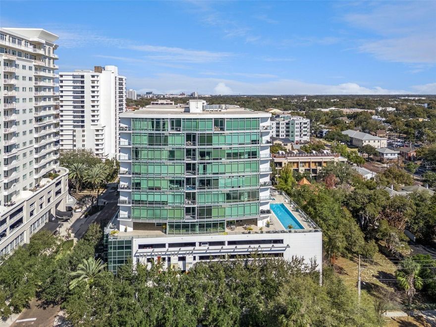 SELLER IS OFFERING A FULL YEAR OF HOA FEES PAID FOR A YEAR! Priced well below market value so that the new buyer can enjoy luxury downtown living in this beautifully updated fifth-floor residence with direct walk-out access to the pool and amenity deck, a rare and highly desirable feature. This spacious unit includes granite countertops, a rare flex room ideal for a home office or guest space, and two deeded garage parking spaces for added convenience. The seller is pricing well below market value due to relocation, creating an exceptional opportunity, and there are no special assessments for added peace of mind. Significant recent building upgrades include brand-new waterproof windows throughout, fresh exterior and interior paint, and well-maintained common areas. Step onto your private balcony to enjoy unobstructed skyline views with the unique bonus of watching rocket launches on clear nights. All community amenities are located on the same level, including a resort-style pool, clubhouse, full fitness center, concierge services, and additional on-site storage available for rent, making this a rare blend of value, convenience, and elevated condo living.