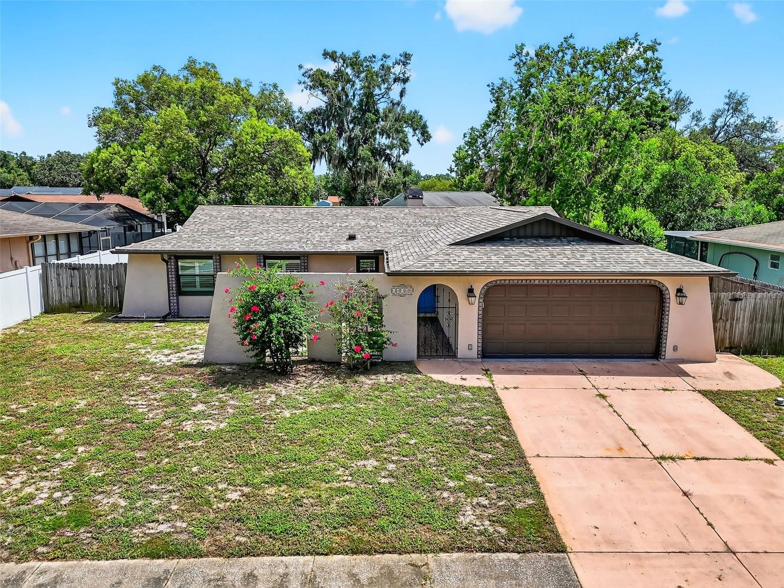 This beautifully maintained home has had all the big-ticket items taken care of for you in recent years—offering peace of mind and energy efficiency. Enjoy a new roof, hurricane-impact windows, sliding glass doors, garage door, and front entry door. A new electrical panel with surge protection, new water heater, updated A/C system, and added attic insulation ensure comfort year-round and help keep your electric bills low—especially during Florida's hot summer months. Step inside to a thoughtfully designed split-bedroom floor plan, providing privacy for all. The open-concept living area seamlessly connects the kitchen, dining, and family rooms—perfect for entertaining or relaxing. The kitchen boasts ample cabinet space and brand-new stainless steel appliances. Cozy up in the spacious family room, featuring a charming wood-burning fireplace and access to the enclosed lanai through sliding doors. The owner’s suite offers a walk-in closet and private en-suite bath, while the enclosed lanai—complete with glass sliding windows—creates a versatile all-season space. Outside, the fully fenced backyard offers a safe and private retreat for pets, kids, or weekend barbecues. Tucked away in a peaceful neighborhood, you’ll feel a world away from the hustle and bustle—yet still be just minutes from US-19, the Veterans Expressway, top-rated restaurants, shopping, and one of the area's best golf courses.