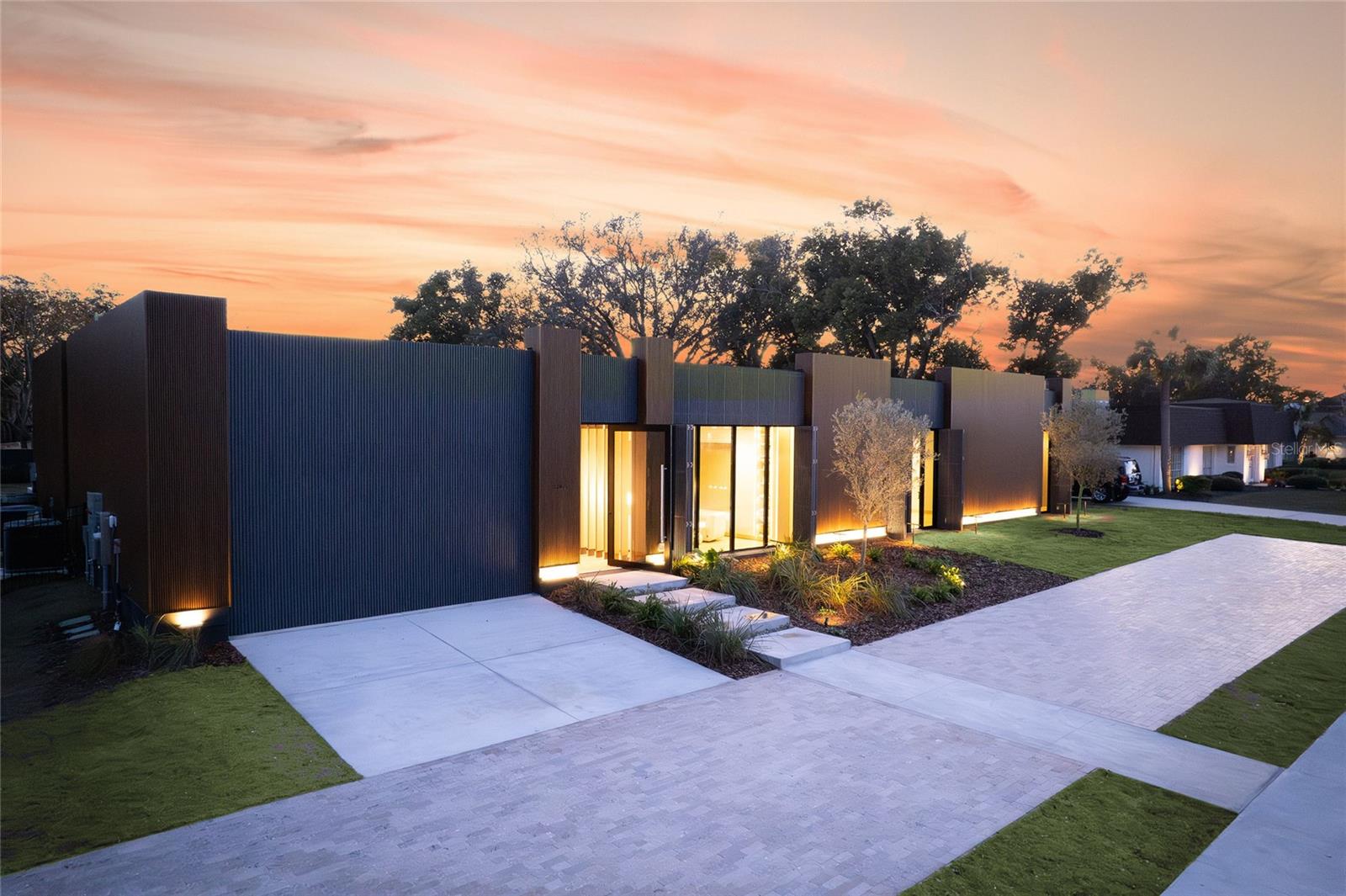 ** PARADE OF HOMES 2025 WINNER!! ** Imagine stepping into a world where ART and Architecture intertwine, where Modern Luxury isn't just a phrase, but a lived experience. Welcome to this BRAND NEW!! exceptional Orlando Florida residence, a DESIGNER Masterpiece unlike any other. This isn't just a house; it's a story waiting to be written.
The journey begins as you cross the threshold, greeted by the warm embrace of Italian hardwood flooring that flow seamlessly throughout the home. The air hums with quiet sophistication, a testament to the integrated Control4 automation system that orchestrates everything from the pool's gentle ripples to the subtle play of light and sound. You're not just entering a home; you're entering a curated environment designed for effortless living.
The heart of this home, the chef's kitchen, is a symphony of sleek design and culinary inspiration. Imagine creating culinary masterpieces amidst the clean lines of the High end Luxury Thermador appliances and the cool, smooth touch of Neolith counters. Every detail, from the Hansgrohe Axor fixtures to the award-winning Duravit toilets and the indulgent Toto Neorest in the master bath, whispers of refined elegance. The cavernous master closet, a sanctuary in itself, promises a place for every treasured possession.
But the true magic lies in the seamless integration of art and architecture. The unique black wood grain shutters, when closed, transform the house into a monolithic sculpture, a testament to visionary design. It's a feature that whispers, "This is unlike anything you've ever seen."
As the sun dips below the horizon, the outdoor oasis beckons. The almost 100-foot pool, lined with shimmering marble stones, invites you to unwind and let the day melt away. The summer kitchen stands ready to host gatherings under the stars, creating memories that will last a lifetime.
Located in the prestigious Bay Hill, home of the PGA tournament, this home places you at the epicenter of Orlando's vibrant lifestyle. World-class dining in Dr. Phillips, the magic of Disney, the thrills of Universal, and the energy of downtown Orlando are all within easy reach. Top-rated schools and renowned restaurants complete the picture, offering a lifestyle of unparalleled convenience and sophistication.
This isn't just a home; it's an opportunity to own a piece of art, a chance to live a story of unparalleled luxury. Don't let this masterpiece slip away. Contact us today to schedule your private showing and begin writing your next chapter.