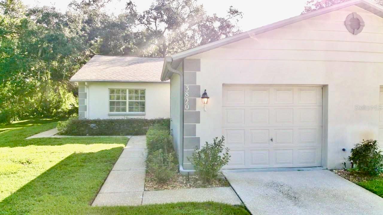 Whether you’re looking for a permanent residence or seasonal retreat, this condo will check all your boxes. You don’t often find such a private and tranquil setting on a cul-de-sac with majestic oak trees, lush green space, and view of the Seven Springs golf course, yet minutes away from shopping, dining, medical facilities, dog parks, beautiful beaches, the famous sponge docks of Tarpon Springs, and more. This 2 bedroom-2 bath home is just waiting for the TLC it deserves, giving you the perfect opportunity to create your own bit of paradise. Split bedroom plan with two primary suites, kitchen with breakfast bar overlooking large living / dining room with cathedral ceiling, inside utility room complete with laundry tub, enclosed lanai, and patio for your cookouts. Want to soak up some of the beautiful Florida sunshine? Then check out the community pool just a few steps away. The River Oaks community offers a relaxed, maintenance-free lifestyle with low monthly HOA fee that includes basic cable, internet, exterior maintenance, roof, trash, pool, maintenance of the grounds, manager, private road, and escrow reserves fund. NO CDD FEE. Roof 2018. Newer AC and water heater. Remediation completed by the HOA in 2014. Don’t miss this rare opportunity. Schedule your private showing today!