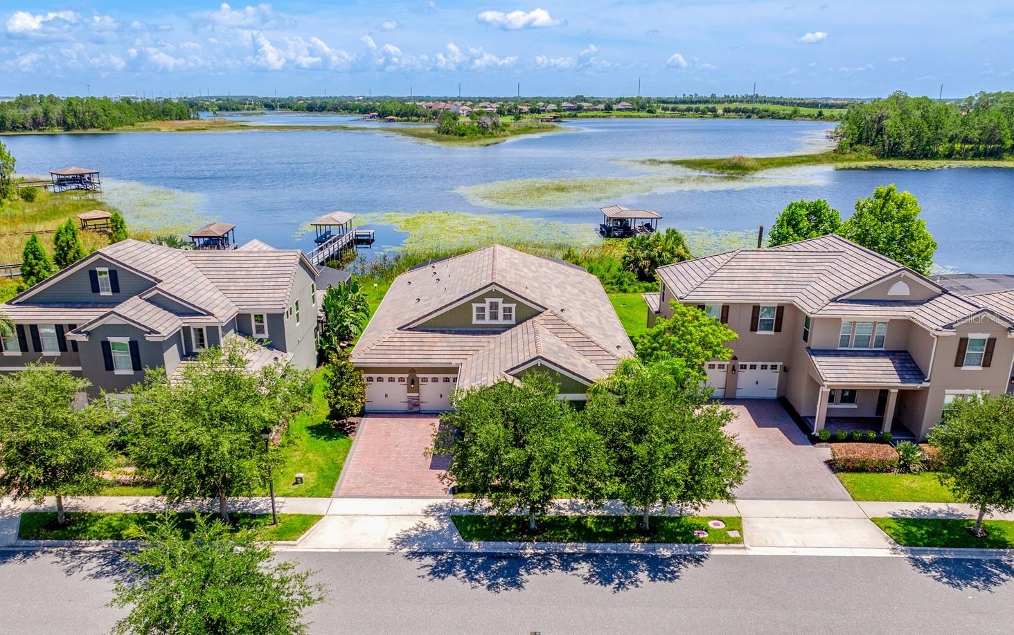 Lakefront property, private pool/hot tub, outdoor living space, and Disney fireworks view! **Welcome to LAKEFRONT LIVING at its finest in the sought-after Waterleigh community of Winter Garden! This stunning 4-bedroom, 3.5-bath single story POOL HOME sits along the shores of SKIABLE HICKORYNUT LAKE, offering panoramic WATER VIEWS, nightly DISNEY FIREWORKS, and a lifestyle that's equal parts relaxation and recreation. From the moment you arrive, the CURB APPEAL impresses with a spacious 3-CAR GARAGE, manicured landscaping, and an inviting covered front porch. Inside, modern design meets everyday comfort with WOOD LOOK TILE throughout the main living areas and plush BRAND NEW CARPET (2025) in all the bedrooms. FRESH INTERIOR & EXTERIOR PAINT (2025), along with a freshly power-washed exterior, porch, and driveway, make this home move-in ready! The heart of this home is a bright, OPEN CONCEPT LIVING SPACE where the kitchen, dining, and living areas flow seamlessly together. Large windows frame the LAKE VIEWS, while a tray ceiling adds architectural interest, defining the space. The kitchen is a true showpiece – timeless yet current – with QUARTZ COUNTERTOPS, STAINLESS STEEL APPLIANCES, a BUILT-IN OVEN, rich cabinetry, coordinating island with breakfast bar, complementary backsplash, and generous pantry storage. Step outside and into your own lakefront retreat – a fully SCREENED lanai, HEATED SALTWATER POOL, and SPA offer the ultimate in indoor-outdoor living. Whether you are entertaining or unwinding, this is the kind of backyard dreams are made of. And yes—you can build your own private dock to launch weekends on the water! Your OWNER’S SUITE is tucked privately at the back of the home and offers spectacular lake views, a spa-like en-suite bath with dual sinks, soaking tub, FRAMELESS GLASS SHOWER (updated 2025), and a spacious WALK-IN CLOSET. Three additional bedrooms offer flexible living, including one with an en-suite bath—ideal for guests or multi-generational living. A mudroom/storage area, convenient half bath, large laundry room, and ample storage complete the thoughtful floor plan. Additional features include double-pane windows, upgraded finishes, and a roof that’s been recently cleaned and maintenanced (2025). Waterleigh is known for its RESORT STYLE AMENITIES: community pool, clubhouse, mini golf, playgrounds, walking trails, and epic seasonal events—Halloween and Christmas are not to be missed! Enjoy TOP-RATED SCHOOLS and the convenience of a grocery store right in the community – with easy access to dining, shopping, parks, and major roadways like SR 429, Avalon Road, and US 192. Built in 2018 and beautifully maintained, this home offers a refined, laid-back lifestyle with every detail designed for your comfort and enjoyment. Plus a front-row seat to some of Central Florida’s best sunsets. Schedule your private tour today and make lakeside living your reality!