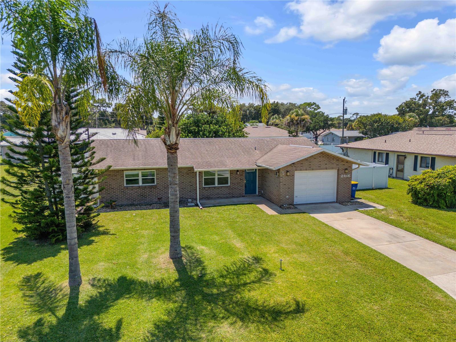 Welcome to this beautifully maintained 3-bedroom, 2-bath home offering the perfect blend of comfort, style, and peace of mind. Never flooded and thoughtfully updated throughout, this home features a spacious 1-car garage (16x21) and a sparkling pool built in 2016—ideal for year-round enjoyment. The large kitchen is a standout, boasting quartz countertops, a breakfast bar, and newer appliances, making it a chef’s dream. Major upgrades include a new roof (2017), hurricane-rated windows (2018), and front and side doors (2020), along with a newer A/C (2017) and water heater (2022). The backyard is fully enclosed with a vinyl privacy fence installed in 2017, creating a private oasis for relaxation or entertaining. With no HOA and short-term rentals allowed, this property offers excellent flexibility and income potential. All of this just 15 minutes from the beautiful beaches of New Smyrna Beach—don’t miss your chance to own a slice of Florida paradise!