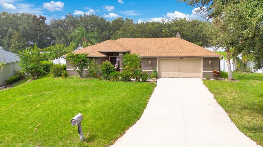 Welcome to your own slice of paradise on nearly half an acre at the top of the hill! As you walk in the double front doors, you will be greeted by beautiful luxury vinyl floors (2020) and vaulted ceilings flanked by an open formal dining room and and living room. Just beyond the half wall, is the heart of the home.  The kitchen is well laid out with plenty of cabinet and counter space and easy access to all of the stainless steel appliances.  The breakfast bar opens up to a dinette and bright family room with wood-burning fireplace!  Take a step through the french doors in the dinette and enjoy the outdoors under the shaded comfort of your extended covered lanai, or venture out into your enormous, fenced-in yard for some outdoor fun!  Back inside, the split floor plan offers plenty of privacy. On one end, you'll find the main bedroom with ensuite with french doors to the lanai. Your private oasis of an en suite includes dual vanities, walk-in shower, and garden tub for soaking. On the other end of the home, you'll find two sizable bedrooms, and an updated guest bathroom (2020). The home also features a newer roof (2018) newer HVAC (2020) and oversized garage for plenty of storage. Don't miss out on this gem, nestled in a small quiet community with low HOA, in the rolling hills of Clermont, FL!