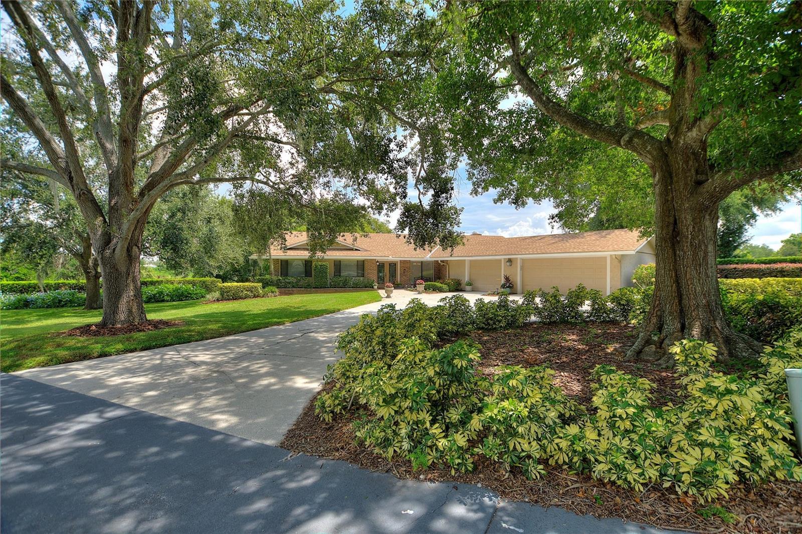 AN AMAZING 4 BEDROOM 2.5 BATHROOM HOME SITUATED ON AN OVERSIZED (.71) AC LOT ON WINTER HAVEN'S FAMOUS CHAIN OF LAKES!!! This home on Spring Lake has amazing water views from the inside of nearly all rooms and especially from the 850 Sq Ft. covered screened patio with oversized pool. Enjoy the shade in both the front and back yards provided by the beautiful oaks while you appreciate the lake breeze! Some NOTABLE UPGRADES INCLUDE: 2 new AC's in 2025, new irrigation pump motor in 2024, new hot water heater in 2023, newer screen panels on cage, and completely replumbed in 2015. The chef in the family will enjoy the great lake view from the kitchen, marble countertops, and double ovens! Cozy up in the family room next to your very unique wood burning brick fireplace. Don't miss out on some of the small details as well with CEDAR FLOORING in all bedroom closets. This home provides an abundance of storage, especially in the hallways and oversized laundry room with utility sink. Never worry about parking again with the large HALF CIRCLE DRIVEWAY and 3 CAR GARAGE. Interlachen is a very established neighborhood with custom homes and sprawling oak tree lined streets. This lovingly maintained property is conveniently located just minutes from DOWNTOWN WINTER HAVEN which has most recently added some AWARD WINNING FINE DINING spots to it's list. LEGOLAND, shopping, medical and entertainment is all withing close proximity of this home as well. Don't miss out on this lakefront opportunity within the City of Winter Haven, a city that's always maintained it's small town charm!