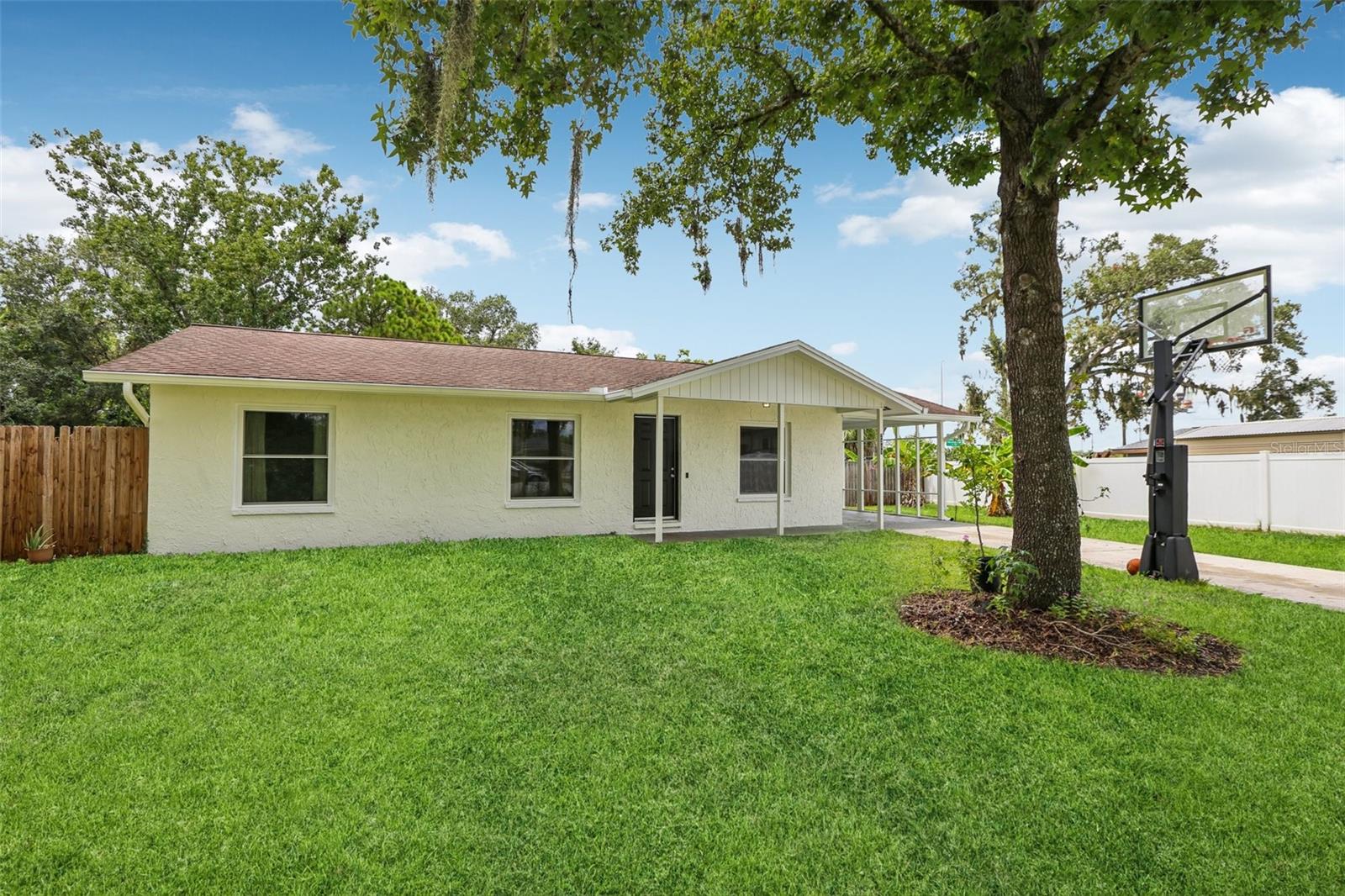 One or more photo(s) has been virtually staged. Welcome to 2307 N Warnell Loop in Plant City, FL! This charming 3 bedroom, 2 bathroom home offers incredible value in a location that blends small-town charm with big-city convenience. Plant City is known as the Strawberry Capital of the World, with year-round community events, local restaurants, and a true sense of hometown pride—all while being just a short drive to Tampa, Lakeland, and Orlando.
Inside, you’ll find an inviting open layout perfect for entertaining and daily living. The kitchen is beautifully updated with quartz countertops and modern cabinets with glass inserts, while both bathrooms feature brand new stylish new tile. Luxury vinyl flooring has been added in key areas, creating a fresh and low-maintenance feel throughout the home. Being so close to the interstate is a dream for your commute to Tampa, or Orlando. The brand new hurricane windows make the home a sanctuary of silence.
Step outside to enjoy the spacious backyard, complete with fruit trees, a playset that conveys with the home, and plenty of room to garden, play, or relax. There’s even a prepared foundation ready for a storage shed or additional parking pad. A NEW ROOF can be installed before closing, completing the renovations needed to make this home move-in ready and designed to give you peace of mind. With TWO double gates at the front entry, a future U-shaped drive is possible. The HVAC was installed October 2023, Hurricane Windows February 2024, Water Heater February 2018, and new insulation and duct sealing was performed in September 2021. This block construction home is not in a flood zone, as new hurricane impact windows, and is built to last!
Whether you’re buying your first home or looking to downsize without sacrificing comfort, this property offers the best of both worlds—modern updates, outdoor space, and a location you’ll love. Request your showing today!
(Basketball hoop and washer/dryer do NOT convey).