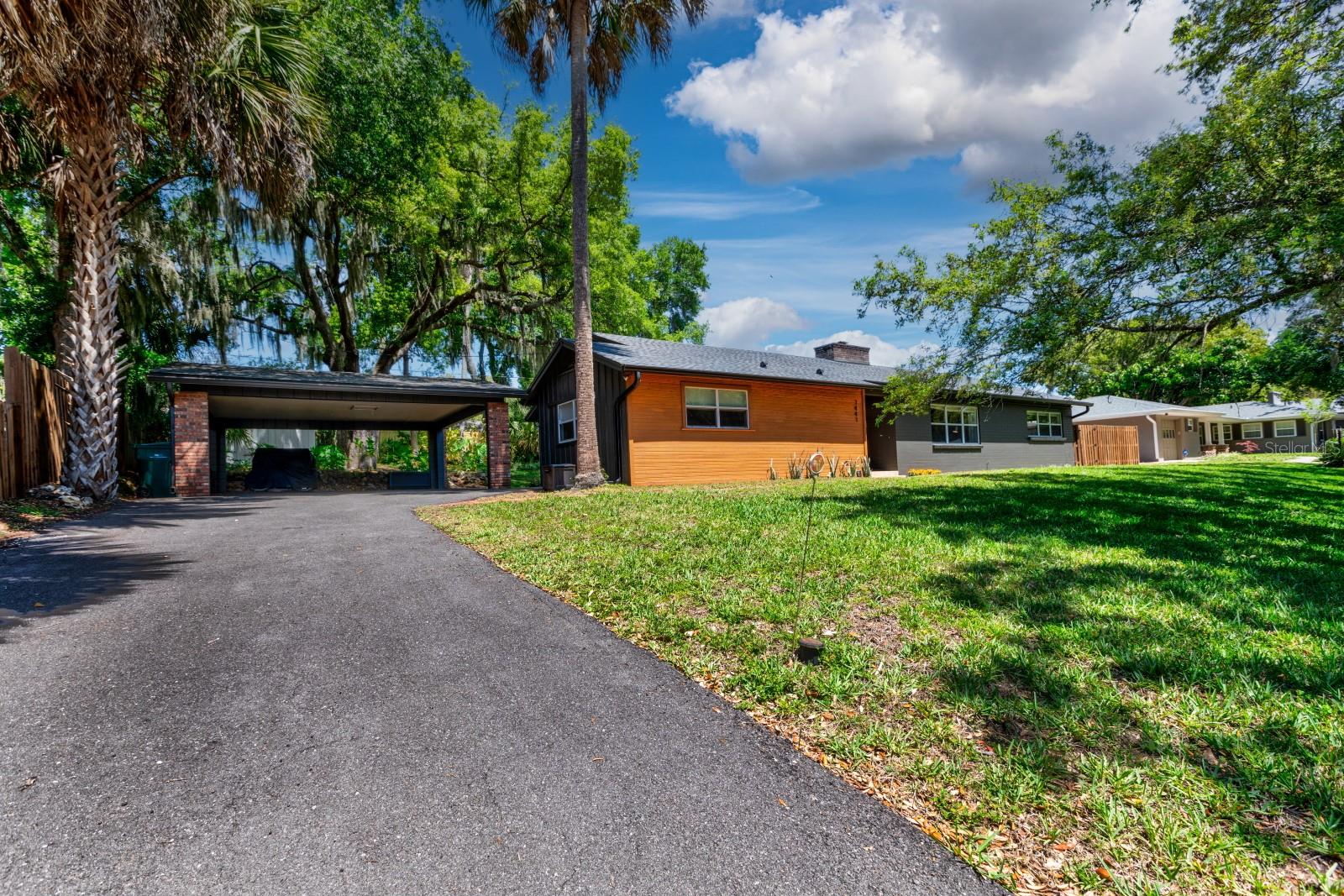 EUSTIS MID-CENTURY CHARMER! Updated, Spacious and Priced to Sell. Perched on a hill overlooking a scenic street in the highly sought after East Crooked Lake area. Open split plan with just enough separation for privacy. The living room is to the right off the foyer and offers relaxing views of the neighborhood with a renovated gas fireplace taking center stage. Circling through to the updated kitchen comprised of center island w/cabinetry, view of the backyard w/pass-through, and newer appliances. Adjacent is the dining which flows into the large family room through French Doors. This room brings the outdoors in with wall-to-wall windows and lots of natural light making it the perfect place for entertaining friends and family or simply relaxing. Master ensuite retreat welcomes you after a long day. Master bath features a long soak or quick shower and two individual above counter sinks. Two additional generous sized bedrooms plus guest bath are situated on the opposite end of the home. A lovely side/backyard includes oversized 2-car carport, storage shed, patio, parameter fencing, lush landscaping, and a sense of tranquility. Fresh paint inside and out with many special touches. Roof is 5 years old. Home is priced to sell quickly so this family can begin a new chapter, and the new owners can enjoy this immaculate and lovingly maintained spot. Located near Mount Dora, downtown Eustis, major highways, shopping, restaurants, medical centers, parks and more. Rush to schedule a showing!