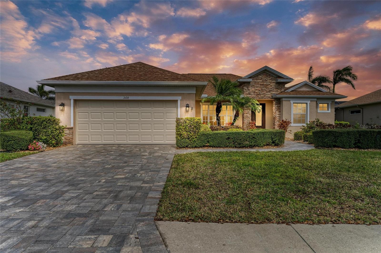 This is the one! ASSUMABLE VA LOAN with a 2.25% INTEREST RATE. Completely updated lakefront home with 2,271 square feet, four bedrooms, three baths and a two-car garage with ceiling storage shelving, heated screened-in pool with lakeview and fenced yard in the gated community of Greyhawk Landing. As you drive up to the home, you will notice the new roof, beautiful landscaping with exterior lighting, custom paved driveway and walkway leading to the luxurious glass front door. Enter through the front door and be captivated with the gorgeous water view of the lake directly behind the home, along with high ceilings with crown molding, a spacious open floor plan making it feel airy and bright and family/dining room combo with glass French doors to the covered paved lanai/pool area, ideal for leisurely afternoons or hosting gatherings. The open kitchen is outfitted with stainless steel appliance with French doors refrigerator, new dishwasher and microwave, granite counters, subway tile back splash, custom 42-inch cabinets, breakfast bar and separate dinette with seamless glass window overlooking the pool and lake. The spacious living room is open to the kitchen making this home ideal for entertaining with additional French doors out to the pool area and a beautiful corner seamless glass window. Step into the primary bedroom with a glass window allowing for tranquil water views and French doors opening up to the pool area. The large primary en-suite bath has dual granite counter vanities, garden tub with separate walk-in shower, private toilet closet, along with his closet and her walk-in closet. The split bedroom floor plan has three additional spacious bedrooms with guest bath and a bonus third full bath with shower with direct access to pool. In the back of the home, you will find a gated area which is ideal for your pets to play. Additional updates include pool resurfaced in 2024, new dishwasher and microwave in 2024, new garage door in 2024, new roof in 2022, new pool pump and heater in 2022, newer water heater and disposal in 2021, gas water heater in 2021 and impact windows. Greyhawk Landing amenities provide an in-person guarded security gate, clubhouse, fitness center, resort-style community pool with lap lanes and kiddie splash play area, tons of nature and walking trails, playground, tennis and pickleball courts, basketball court, soccer fields, baseball diamond and fishing dock. Enjoy top-rated schools. Conveniently near a variety of entertainment options, dining and easy access to Interstate 75, this home has it all. Don’t miss your chance to experience this exceptional property, schedule your private showing today and make this dream home yours.