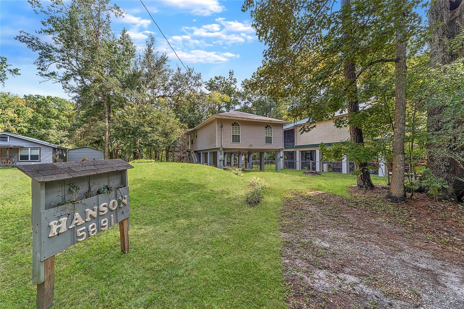 Turnkey Waterfront Retreat on the Withlacoochee Canal- Escape to this charming 2-bedroom, 2-bath stilt home nestled along a peaceful canal with direct access to the scenic Withlacoochee River. Fully furnished and move-in ready, this property is ideal as a weekend escape, full-time residence, or an income-generating rental. Step inside to find a light-filled kitchen flanked by both a cozy living room and a separate gathering space—each anchored by a rustic stone-surround wood-burning fireplace. Whether you're entertaining or unwinding, the layout of this home offers comfort and flexibility. Outside, enjoy tree-lined privacy and a spacious deck perfect for morning coffee, evening cocktails, a barbecue, or simply soaking in nature. Launch your canoe or kayak just steps from your door and explore peaceful relaxation on the tranquil waters of the Withlacoochee. Bring your fishing poles, too, since these waterways are well-known for prime bass fishing! Additional features of this home include two full bedrooms and bathrooms, a convenient laundry closet designed for a stackable washer/dryer, covered parking, and a downstairs utility room for extra storage space. The location of this home is very private yet just a few miles from waterfront dining at Stumpknockers Restaurant and the SR200 corridor, offering multiple options for shopping, dining, and medical facilities. Whether you're seeking serenity, adventure, or a smart investment, this canal-front gem delivers.