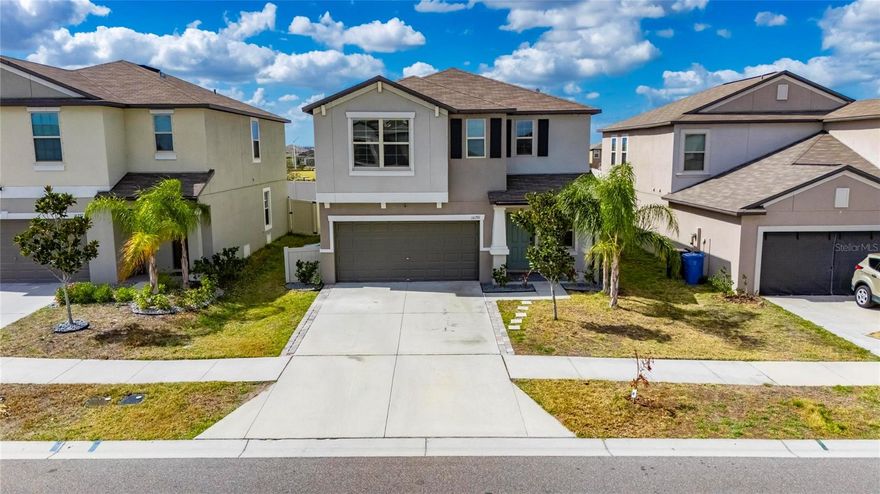 Welcome to this exceptional 2022-built residence offering the perfect blend of modern design, comfort, and effortless Florida living. With six spacious bedrooms, three full bathrooms, and a versatile loft, this thoughtfully designed two-story home provides extraordinary space and flexibility for today’s lifestyle.

From the moment you arrive, the home’s beautiful curb appeal and low-maintenance landscaping create a polished first impression. Specialized exterior lighting elegantly enhances the façade, allowing you to showcase the home for holidays, special occasions, or simply enjoy a warm, ambient glow in the evenings.

Inside, tile flooring flows seamlessly throughout the first floor, complementing the expansive open-concept design and soaring ceilings. The generous living and dining areas create an inviting atmosphere ideal for both intimate gatherings and large-scale entertaining. At the heart of the home, the kitchen is as functional as it is impressive, featuring granite countertops, abundant prep space, stainless steel appliances, and an oversized island with ample seating. The kitchen opens beautifully to a dining area spacious enough to accommodate a ten-person table, creating a natural setting for memorable meals and celebrations.

A highly desirable first-floor bedroom and full bath provide exceptional flexibility, ideal for guests, multigenerational living, or a private home office. Sliding glass doors from the family room lead to the outdoor patio and fully fenced backyard — your own private retreat and slice of Florida sunshine.

Upstairs, a generous loft offers additional living space perfect for a media room, playroom, study area, or fitness space. Five well-appointed secondary bedrooms provide comfort and versatility, ensuring room for everyone and everything. An additional full bathroom with countertops and dual sinks supports the needs of a busy household with ease.

The split floor plan enhances privacy for the primary suite, a true sanctuary designed for rest and relaxation. This spacious retreat comfortably accommodates large furnishings and features dual vanities, a separate water closet, a walk-in closet, tiled flooring, and a private shower area — thoughtfully designed for both luxury and functionality.

Throughout the home, a neutral color palette and modern finishes create a timeless aesthetic. Only four years young, this residence is move-in ready and waiting for you to make it your own.

Residents enjoy access to community amenities including a cabana-style pool, clubhouse, playground, and basketball courts, all with a low HOA fee. Ideally situated near major highways, medical facilities, shopping, dining, MacDill Air Force Base, and the beautiful Gulf Coast beaches, the location offers both convenience and lifestyle.

This remarkable six-bedroom home delivers the space, comfort, and setting you’ve been searching for. Schedule your private tour and experience everything this stunning property has to offer.