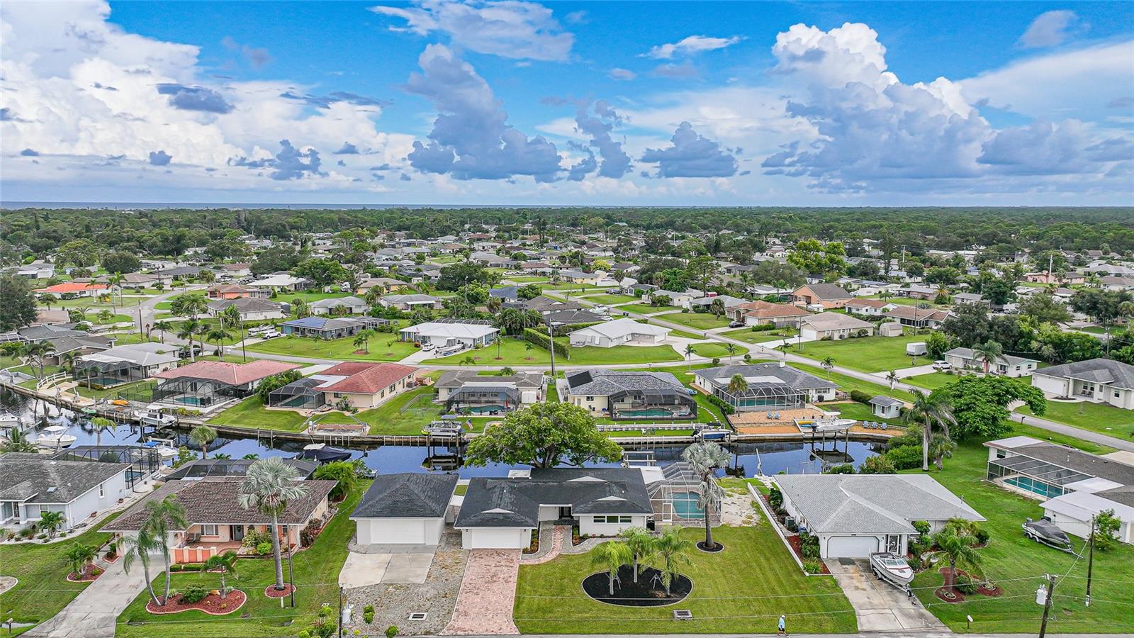 One or more photo(s) has been virtually staged. Live the coastal lifestyle in this fully remodeled pool home on two sailboat-access lots in Overbrook Gardens—less than 10 minutes to the Intracoastal. Spend your days boating from your private dock with lift, swimming in the heated pool, or relaxing on the screened lanai with wide canal views. An attached 2-car garage and a 900+ sq ft detached garage with 10-ft door, car lift, mini-split A/C, and storage shed provide space for cars, boats, and hobbies.
Inside, natural light fills the open layout with hurricane-impact windows and LVT flooring. The kitchen is designed for both style and function with quartz counters, wood cabinetry, stainless appliances, and tile backsplash. The primary suite offers a tiled walk-in shower, while the guest bath is equally updated. A/C was replaced in 2022, and a whole-home generator adds peace of mind.
This Englewood location is minutes from Manasota Key and Englewood Beach, Venice, Wellen Park, and the shops and dining of Dearborn Street. Overbrook Gardens offers an optional HOA with access to a private boat ramp, making this home the ideal blend of waterfront living, recreation, and convenience.