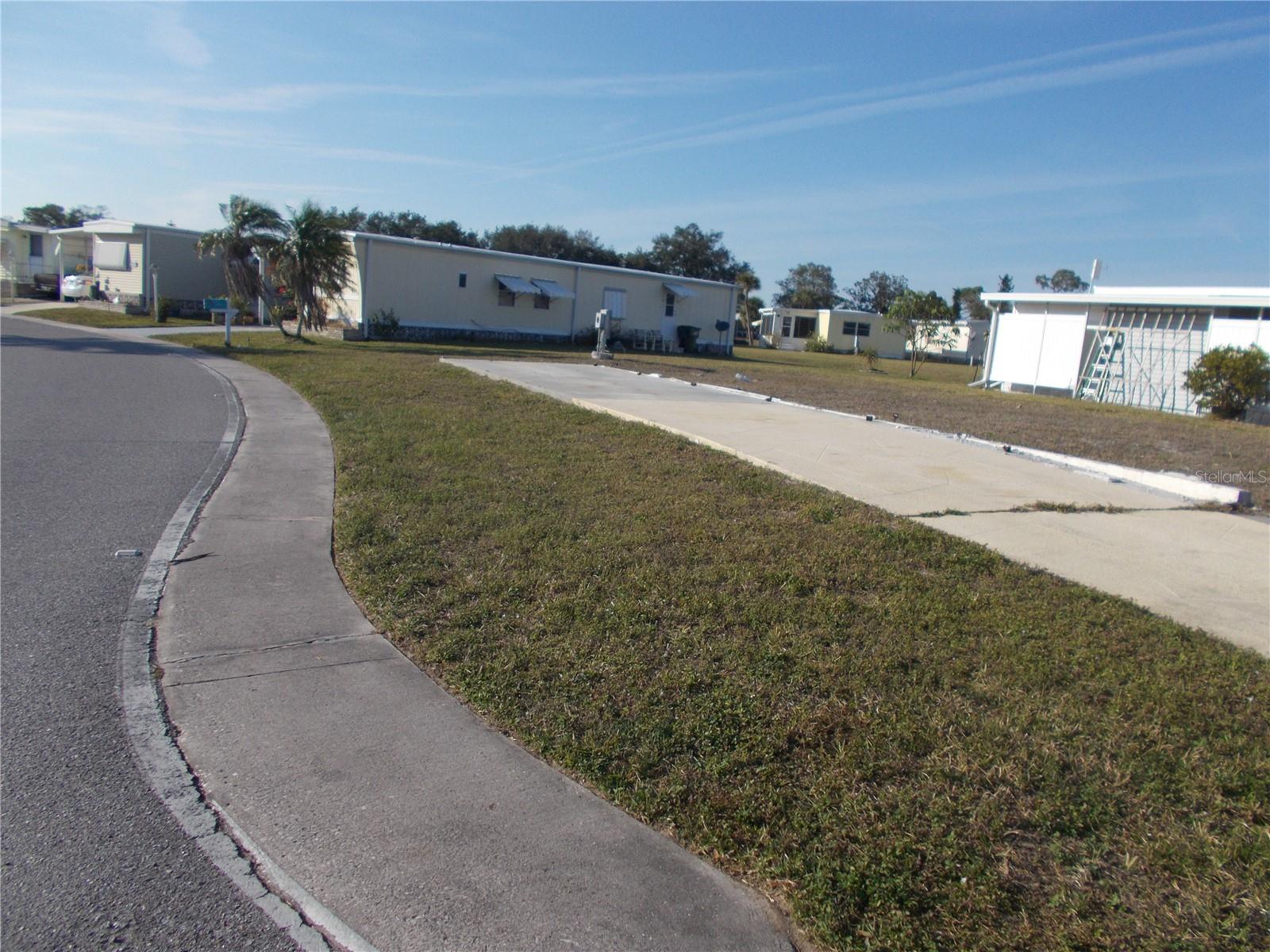 Vacant land in sought after 55+ Gated Community of Holiday Park and in the Pet Section. This property is located on the corner of Center Lane and Holiday Park Blvd. This lot is 5,134 square feet and had a double wide mobile home on it. Seller left driveway. In Holiday Park you own the land with a deed and the maintenance fee of $2340.00 a year ($195.00 a month) is included in your taxes. Holiday Park offers many amenities including 2 Pools, Tennis Courts, Pickle Ball, Bocci, Shuffleboard, Laundry, Library, Horseshoes, Bingo, plus other card games, Fitness Room and so much more. This home has been pulled off and the electric and water are in place. This is a perfect place for your new manufactured home. Come and see!