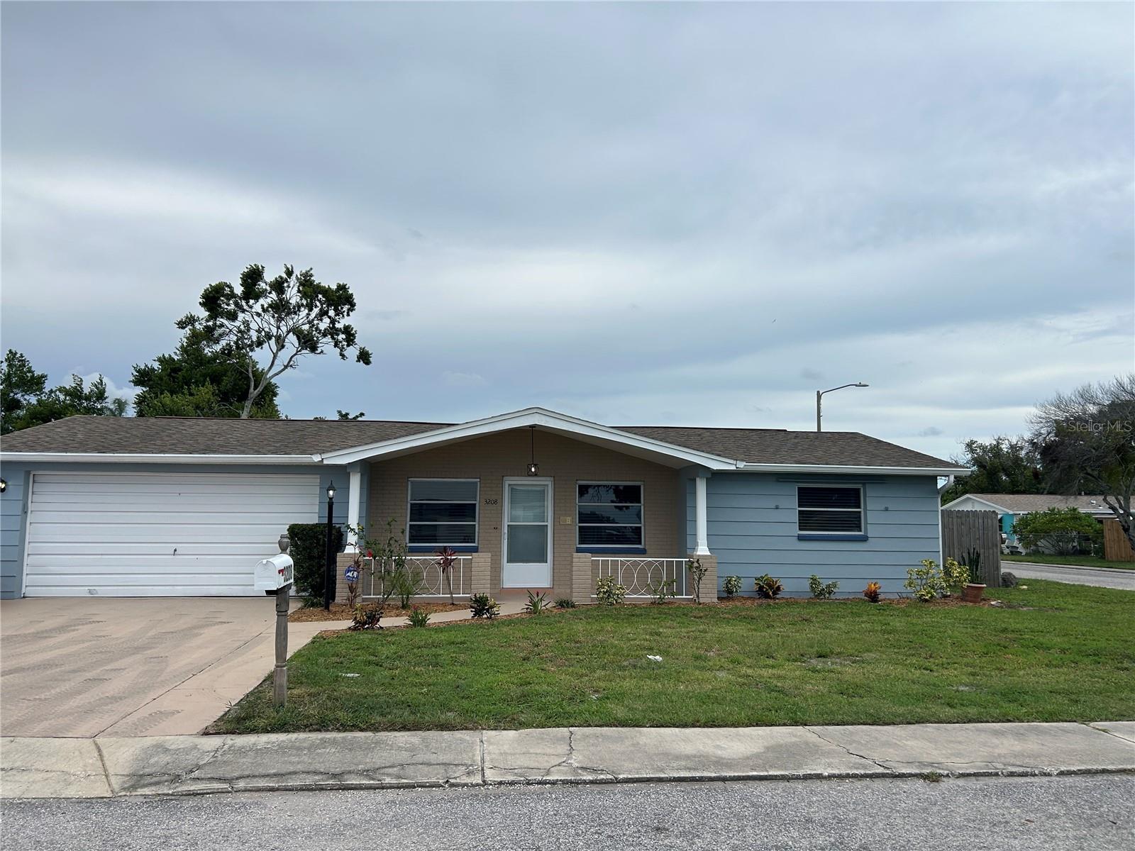 DON'T MISS THIS OPPORTUNTIY: to own this 3 BEDROOM, 2 BATH, 2 CAR GARAGE home on an oversized FENCED CORNER lot! Take notice of the beautiful curb appeal as you drive up with new exterior paint, landscaping and an inviting front porch. Rare to find a 2 car garage with a widened driveway that can accommodate any vehicles. The rear yard has an enclosed covered/screened porch, looking out to the large area for privacy and has plenty of room for entertaining and recreation activities. Enter through a glass etched door with storm door that can be open for air flow. Natural light from all the windows make it bright with the open floorplan having a living/dining room in front that flows to the dinette/kitchen area in middle of home to the large family room in the rear. It has split bedrooms with the en-suite master in the rear (walk in cedar closet) and 2 additional bedrooms (oversized) on the opposite side of the home (bed 3 has double wall closets). All tile throughout the main living areas with luxury vinyl wood floors in the bedrooms. NO CARPET, making it EZ to clean, maintain and great for those with allergies. There are 2 inch blinds on all windows. THIS HOUSE IS IN MOVE IN CONDTION! just ready for your personal touch. Super clean and new interior updates include: fresh neutral paint, stainless appliances, baseboards, bath/vanity. The AC was replaced within 2 yrs. and the roof is in good condition with many years left. Great location in the Tri-County area; close to Rt. 19 for all the shopping & restaurants in Pasco and Historic Tarpon Springs is a short distance in Pinellas, with access to the Tampa Bay area of Hillsborough County. Of course close to area beaches. (flood insurance not required). GREAT VALUE for this beautiful home!