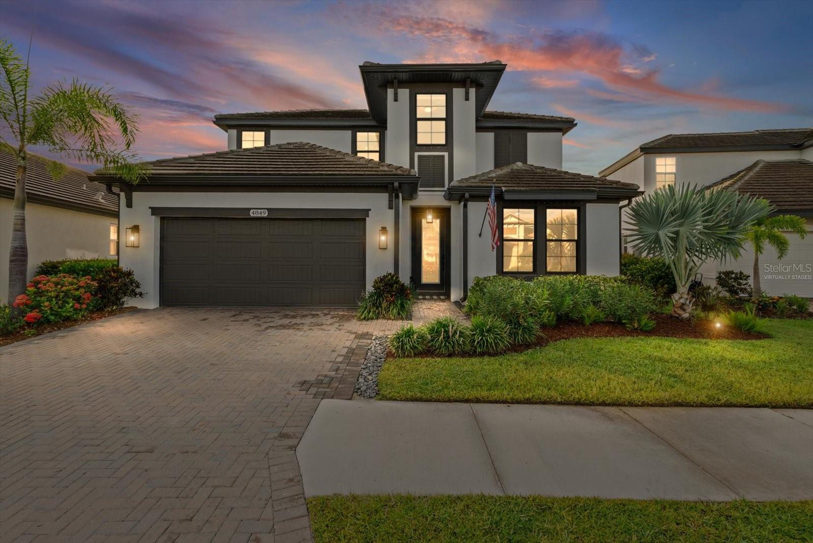 Serene Mornings, Timeless Design, and Seamless Living -
Located in the gated community of Worthington, known for its beautiful lakes and peaceful nature trails, this thoughtfully upgraded home offers comfort, privacy, and elegant indoor-outdoor living.
The spacious first-floor primary suite is a true retreat, featuring tray ceilings, a custom closet, and a spa-inspired bath with a garden tub, dual vanities, and a luxurious rain shower. On the opposite side of the home, a private guest suite with a walk-in closet offers comfort and separation for visitors. A spacious den with glass French doors makes the perfect home office or flex space.
Designed for both daily life and entertaining, the gourmet kitchen includes a 5-burner gas cooktop, designer hood, wall oven and convection microwave combo, an oversized walk-in pantry and a center island. Quartz countertops, upgraded cabinets, 8' doors, and crown molding are among the many upgrades featured in this home. The main entryway features custom wainscotting and the open concept living room boasts double sliders that open the entire back of the home to a screened paver lanai and pool deck. Enjoy stunning sunrise views and total privacy, thanks to mature areca palms lining the backyard.
With designer lighting, custom window shades throughout, including motorized ones on the sliders, and walls of windows that fill every room with natural light, this home feels open, bright, and beautifully finished. A beautiful wood staircase with open banister leads upstairs, to two additional bedrooms, a third full bath, and a spacious playroom providing flexibility for family or guests.
With a tile roof, paver driveway, custom lighting and elevated touches throughout, this home offers polished ease and timeless appeal - all in one of Sarasota’s most welcoming and well-maintained communities.
