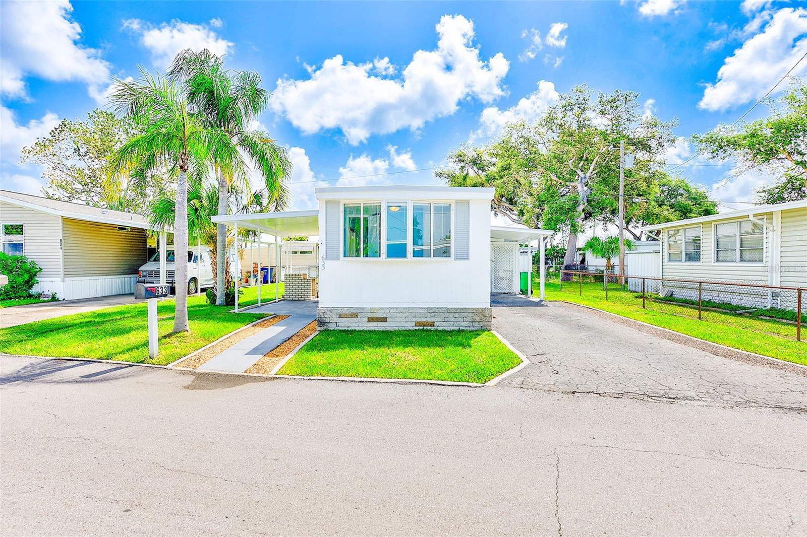 Welcome to this completely renovated 3-bedroom, 2-bathroom mobile home situated in an all-ages community directly on the scenic Pinellas Trail. This meticulously updated 720 square foot residence showcases thoughtful improvements throughout, making it move-in ready for discerning buyers. The interior features brand new vinyl flooring and sub-flooring throughout, complemented by fresh baseboards. The kitchen is completed with New white shaker cabinetry, NEW gas range, NEW refrigerator, NEW built-in microwave and a NEW electric dispose-all. Both full bathrooms have been completely renovated with NEW vanities, sinks, toilets, and updated plumbing fixtures. Recent upgrades include new electrical breakers, interior and exterior paint, contemporary lighting, and vinyl window shades on all windows. NEW closet folding doors enhance storage accessibility throughout the home. The 50-gallon water heater, installed less than a year ago, ensures reliable hot water supply. Exterior improvements include a new vinyl roof installed in 2017 (transferable warranty), NEW wrap-around skirting, and custom curbing with fresh landscaping. The property remained undamaged during recent hurricanes, demonstrating its resilient construction on high and dry ground. Pet owners will appreciate the 10x10 fenced area perfect for furry companions or gardening. An enclosed 12x20 work and laundry area features newer stackable washer and dryer units. The home was professionally fumigated for termites last August, providing peace of mind. Location benefits include proximity to Seminole City Center, Recreation Center, and 2 miles from beautiful beaches. The community welcomes pets, LOW HOA fees $150 a month, and offers direct trail access for outdoor enthusiasts. This turnkey property combines comfort, convenience, and quality updates in a desirable Seminole location.