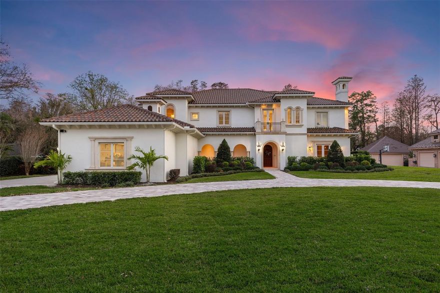 Located within a gated community of just 10 homes—only four of which enjoy direct lakefront access—this Mediterranean-inspired estate is truly one of a kind. Situated on Odessa’s pristine 79-acre ski lake, Lake Pretty, the property offers over 150 feet of waterfrontage. The property spans more than 6,000 square feet on 1.07 acres. A newly paved circular driveway (2024) welcomes you to this stunning residence, where exquisite curb appeal is matched by functional design. The hidden garage, designed for the true car enthusiast, features three individual car bays plus a separate two-car bay with dual doors—one facing the driveway and the other opening directly toward the lake, perfect for boat or jet ski storage. As you step into the home, you are immediately greeted by a breathtaking view of Lake Pretty through the windows of the main living room. The grand foyer features a spiral staircase and a chandelier, complemented by soaring ceilings. Throughout the home, meticulous trim, intricate crown molding, and expert carpentry showcase an unmatched level of craftsmanship and attention to detail. At the end of the first-floor hallway, the home is equipped with a climate-controlled wine cellar. On the opposite end, you’ll find the true “heart of the home”: the kitchen and living room, both designed to maximize natural light and stunning views of the pool and Lake Pretty. The chef’s kitchen is a masterpiece, featuring a large island, freshly painted wood cabinetry, a mini bar, and updated dual pantries and a butler’s pantry (2024)—ideal for hosting gatherings of any scale. Adjacent to the kitchen, the grand living room impresses with soaring ceilings and expansive windows that beautifully frame the outdoor living space and lake. The home offers five bedrooms, an office, and a versatile bonus room that can function as a gym, media room, or even a sixth bedroom with the addition of a closet. Upstairs, you’ll find the primary suite, three guest bedrooms, the bonus room, and a laundry room. The first floor houses the office and a fifth bedroom. Each bedroom has its own ensuite, with two additional half baths on the main floor catering to guests. The primary suite features a large walk-in closet, a grand bathroom with a tub and shower, and access to a sprawling second-story balcony. This balcony spans the entire rear of the home, connecting to a guest suite and providing uninterrupted views of Lake Pretty. The outdoor living spaces are equally captivating. A covered lanai features a brand-new outdoor kitchen (2024) and a private above-ground hot tub with added privacy. A resurfaced and retiled (2024) heated saltwater pool offers panoramic views of Lake Pretty, while the expansive backyard provides space for recreation and enjoying the outdoors. A private dock, fully equipped with electricity and a boat lift, ensures seamless access to the lake for boating and water sports. This rare offering includes over $200,000 in recent upgrades. A handful of notable improvements include fresh exterior paint (2024), a roof replacement (2021), new driveway pavers (2024), a newer lanai screen (2022), pool heater (2021), new carpet (2024), and newer AC units (1 - 2025, 2 - 2024, 3 - 2020, 4 - 2020). A detailed list of improvements is available upon request, underscoring the home’s care and move-in readiness. The home is Flood Zone X (not in a flood zone). Don’t miss the opportunity to experience lakefront living in Odessa—schedule your private showing today.