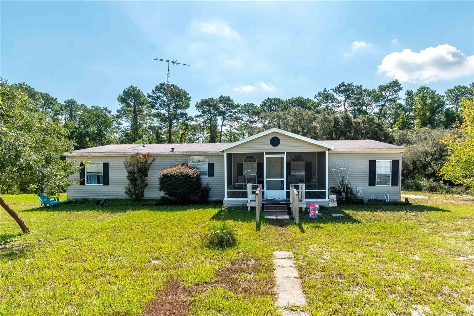 Escape to your own private retreat on this stunning 19.31-acre parcel nestled in native Florida beauty. This 3-bedroom, 2-bathroom double-wide mobile home features a screened front porch, and serene surroundings teeming with wildlife. The property backs directly to the Ocklawaha River, with Sunnyhill Restoration Area just across the water — offering tranquil, protected views and a sense of unspoiled seclusion. Create your own nature trail to the river!
This spacious acreage includes a storage shed and two carport-style awnings for additional covered parking or equipment storage. Whether you're looking to enjoy peaceful country living, create a homestead, or invest in acreage with waterfront potential, this property is a rare find in the heart of Ocklawaha.
An older single-wide mobile home is also on the property and conveys in as-is condition.