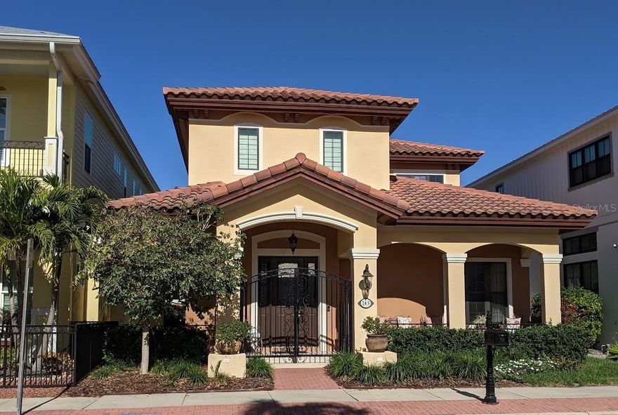 Discover Safety Harbor living in this Spanish-Mediterranean home. Nestled in vibrant waterfront Safety Harbor on Tampa Bay, this residence offers comfort, style, and convenience. Imagine strolling the marina, enjoying local shops and restaurants, or exploring parks and beaches. Just a short drive from Clearwater Beaches and St. Pete Pier, all Tampa Bay amenities are at your fingertips. Built to last, this two-story home boasts concrete block construction, impact windows, and a stucco finish. Enjoy peace of mind – this property has remained high and dry for a decade, safely outside the flood zone. Exquisite Spanish architectural details set this home apart, from intricate wrought iron accents and the entry doors to the classic Spanish tile roof. A beautiful front facade welcomes you, while rear access leads to a two-car garage and delightful patio—perfect for relaxing. Step inside to be enchanted. The inviting foyer leads to the expansive great room. A gas fireplace takes center stage, creating a focal point. The elegant wrought iron staircase enhances the craftsmanship. A discreet half-bath is readily accessible. To the left, a formal dining room awaits, perfect for hosting memorable meals. This elegant space flows seamlessly into the open-concept kitchen—a chef's delight with rich wood cabinetry, ample counter space, and a central island. Customize the space with your culinary tools. A breakfast nook offers casual dining and access to a private lanai—ideal for morning coffee. Step out to a small garden and enjoy convenient driveway access. The two-car garage is also easily accessible. Between the staircase and kitchen, a cleverly designed bar area serves the living and dining rooms, as well as the adjacent Den. This versatile Den, complete with a glass-doored walk-in closet, is currently a library, a testament to its adaptability. Throughout this exceptional home, find a harmonious blend of natural wood floors, elegant ceramic tile, and tasteful architectural details. From crown moldings to rich wood finishes and built-ins, every element exudes the timeless elegance of Spanish-Mediterranean style. Upstairs, a refreshing mosaic landing