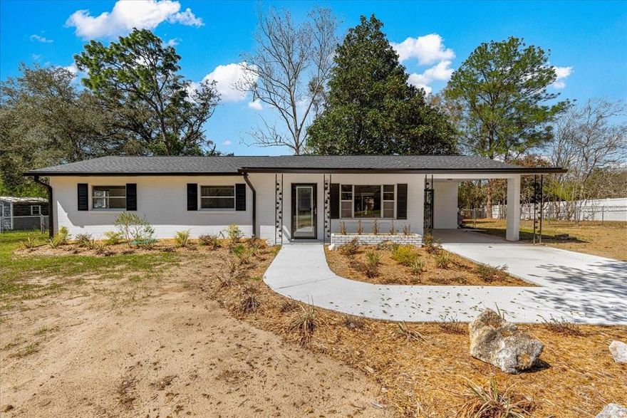 Step inside this fully renovated home with an open-concept living, dining, and kitchen area featuring new LVP flooring and ceiling fans throughout. The updated kitchen boasts a new stove, microwave, dishwasher, and sink, perfect for cooking and entertaining. Both bathrooms have been completely updated, with the primary bathroom offering a new vanity, sink, toilet, and a walk-in tiled shower, while the guest bathroom features a new vanity, sink, toilet, and a shower/tub with tile flooring. Enjoy the large 16x12 screened-in lanai, an ideal spot to relax or entertain while taking in the gorgeous view of the oversized backyard. Outside, the home shines with a new roof and gutters, freshly repainted exterior, beautifully landscaped front yard, and a newly repaved concrete driveway leading to a covered carport. The fully fenced backyard is perfect for pets, play, and gatherings, with a convenient storage building for tools and equipment. This home is ready for you to move right in, combining modern updates with comfortable living. Schedule your private tour today!