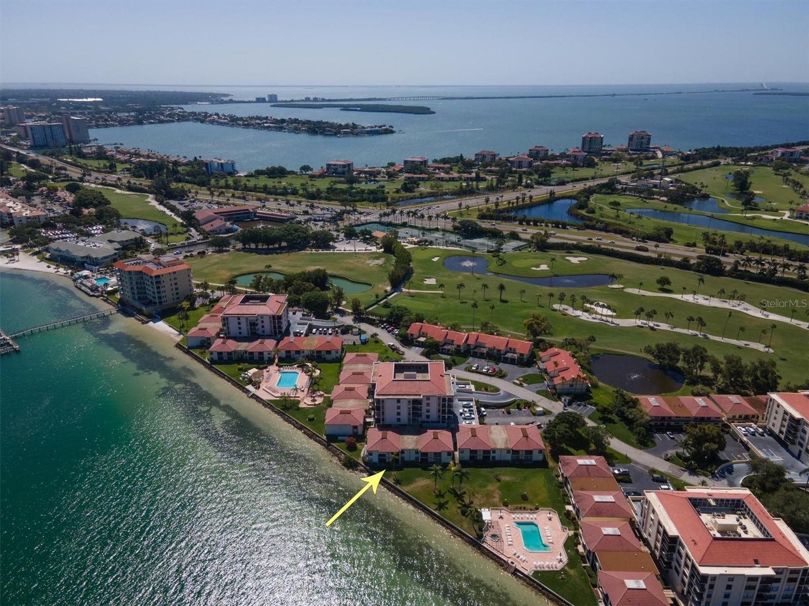 Beautiful 2/2 ground floor villa with gorgeous wide open views of Boca Ciega Bay! The kitchen and baths have been fully and professionally remodeled; the kitchen features solid wood cabinetry, beautiful granite countertops and stainless steel appliances. Other updates include master and guest baths, attractive ceramic tile flooring throughout, and AC system and water heater. The sliding doors and windows are impact resistant and perfectly frame the spectacular water view! The private screened patio will soon become your favorite place to relax, first thing in the morning with a cup of tea and at the end of the day with a chilled glass of wine, watching boats glide by, pelicans diving for fish and on a lucky day, dolphins swimming by. The master bedroom is waterside, so more great views of the Bay, while the split bedroom plan affords privacy when you have guests. Additionally, there is an interior laundry closet with a GE Profile one-piece washer/dryer. Assigned under-building parking space #19 is truly just steps from the front door! There is a storage closet on the patio and additional storage space in the storage room on the second level of building B. Social gatherings are held in the recreation room, complete with bar area and pool table, and there is a community laundry facility for residents. The large resort-style heated pool and spa area, overlooking Boca Ciega Bay, is the perfect place to unwind and read a book or take a dip in the pristine pool and swim a few laps to cool off. And if you wish to fully indulge in waterfront living, there is storage for your kayak! Please come by and preview this beautiful, spacious villa (915 sq ft) - great for a vacation getaway, rental investment or full-time residency in the Sunshine State. This is your opportunity to make the Florida lifestyle your lifestyle, with white sandy beaches and wonderful Ft DeSoto Park close by, as well as restaurants, shopping, theater, sports, museums, 2 Intl Airports and much more! Small pet welcomed and 30 day minimum rentals permitted. Buyer to verify all room measurements.