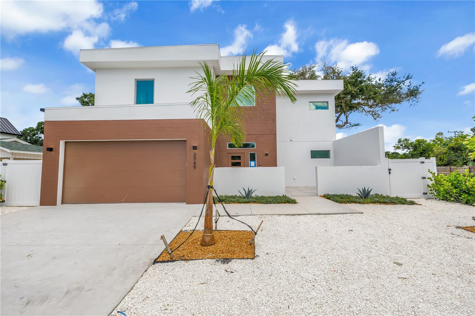 Experience refined coastal living in this newly constructed luxury residence located in the heart of Sarasota. This thoughtfully designed home offers over 3,600 square feet of living space, creating the perfect blend of comfort, privacy, and functionality for family and guests alike. From the moment you enter through the grand courtyard entryway, you are greeted with soaring ceilings and elegant architectural details throughout. The open concept floor plan flows effortlessly through the main living areas, where natural light pours in through oversized sliding glass doors, seamlessly connecting the indoors to the serene outdoor oasis. The gourmet kitchen is the heart of the home, featuring high-end appliances, custom cabinetry, a walk-in pantry, and a generous waterfall quartz center island with seating that borders a formal dining area and an inviting family room that overlooks the resort-style backyard. Step outside to your private fenced-in oasis, where a spa spills into a custom-designed saltwater pool that surrounds a cozy recessed gas fire pit, making it perfect for entertaining year-round. The amazing outdoor space also features a dedicated pool house that includes a half bath and a private outdoor shower, and has an attached outdoor kitchen with a built-in grill, sink, refrigerator, and bartop seating. Each of the six spacious bedrooms has been carefully planned for relaxation and style, equipped with a private en suite bathroom and a custom walk-in closet. Additional highlights include a second-floor rear lanai balcony, a full-size laundry room with a utility sink, and a two-car garage with ample storage. What's more, the home is located in one of Sarasota’s most desirable residential areas, allowing short-term weekly rentals and offering a rare combination of elegance, comfort, and convenience just minutes from world-class beaches, vibrant downtown Sarasota, fine dining, and shopping. *Interior images are of a similar model home for illustrative purposes only. Actual finishes and features of the property may vary upon completion.*