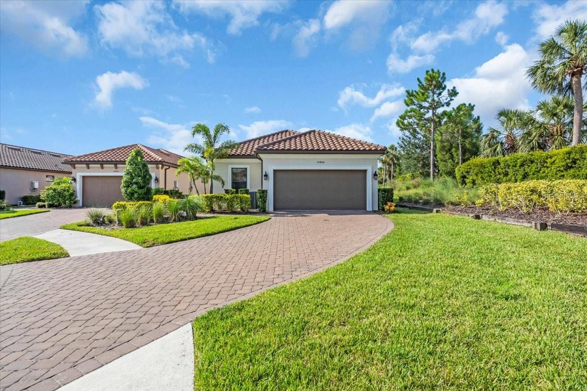 Welcome to this wonderful 3-year old home located in the highly desirable Esplanade of Artisan Lakes in North Manatee County. This home was planned for your comfort and convenience. It features a top-of-the-line Jacuzzi hot tub with lighting and a waterfall in the 46’x22’ Lanai. The screened-in Lanai has upgraded pavers and a scenic panoramic view of the gorgeous lake behind the home. The Living Room is equipped with motorized shades to control your lighting environment, all of the home’s sinks have instant hot water heaters, and all of the closets have custom wood build-ins! If the electricity goes out, it is all powered with a whole house generator. This Arezzo model has 1,950 sq. ft. of living area with 3 bedrooms, 2 bathrooms, a den/study and a separate dining room. The 10’ high ceilings, 8’ tall doors and tray ceilings help expand the spaciousness. The floors are an upgraded wood-grain tile throughout, with carpet in the bedrooms. The efficient U-shaped kitchen offers lots of work space, plenty of light gray 42” cabinets, quartz countertops, and a wine refrigerator that stays with the home. The Owner’s Suite has triple windows with views of the lake and an en-suite bathroom with quartz countertops, dual sinks, a frameless glass walk-in shower and a spacious walk-in closet that has been professionally built out to keep you well organized! Bedrooms 2 and 3 are at the front of the home providing separation from the Owner’s Suite. The second bathroom is adjacent to the second bedroom so that it could be used as an en-suite bathroom. This bathroom has a combination tub/shower and quartz countertops. The office/den has pocket doors for privacy, a ceiling fan and has wood-grained tiled floors. The laundry room includes the washer and dryer which stay with the house. Plumbing in the laundry room is roughed-in for a utility sink. Home ownership in the Esplanade entitles your family and guests to full access of all of the wonderful amenities. The Community Center has a state-of-the-art fitness center with locker rooms, a large event space with a kitchen, and an on-site lifestyle director to coordinate special events and activities. You can enjoy the beautiful resort-style swimming pool with cabanas, a resistance pool, a hot tub, an outdoor fire pit, tennis courts, pickle ball and bocce ball, all in a park-like setting. There are walking trails, dog parks and a playground. A second amenity center in the community called “ The Venue” has a beautiful pool and hot tub. Inside is a large gathering area for games, club meetings and in a separate area is a room with large TV’s, a pool table and ping pong. The HOA provides all of these great amenities plus cable TV, internet service, yard maintenance and irrigation. Don’t miss out on this great opportunity!
