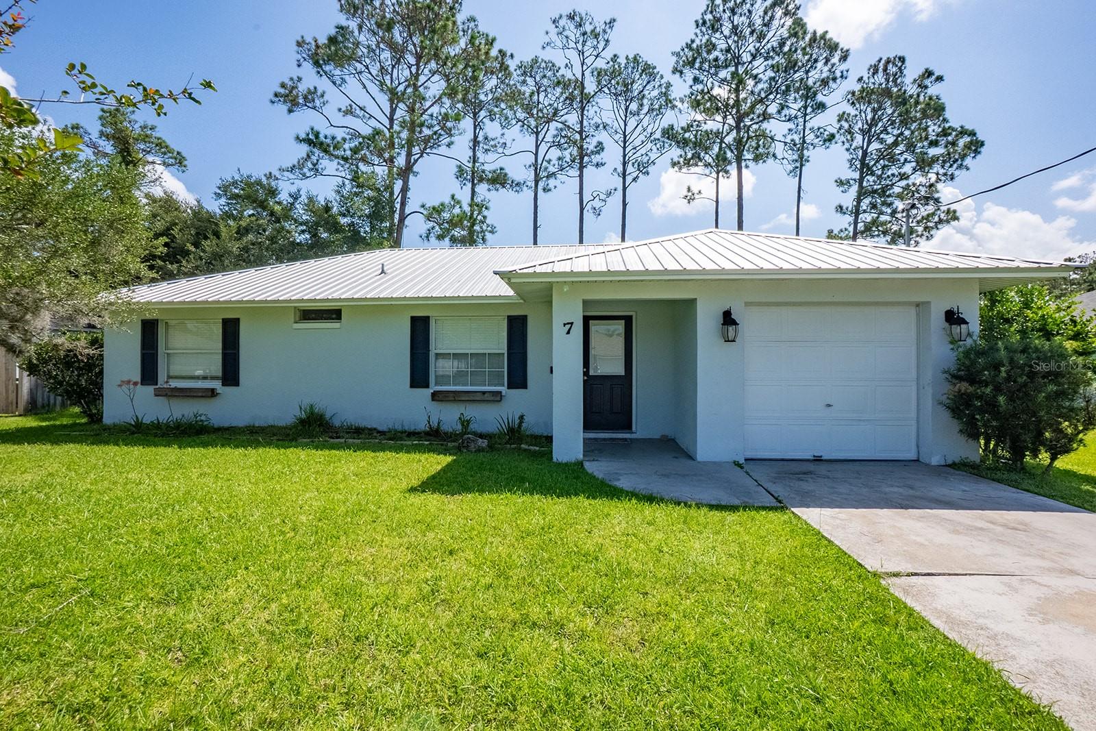 This adorable three bedroom two bath one car garage home is tucked away on a quiet cul-de-sac street just minutes to Palm Coast Town Center and only 6 miles to beautiful Flagler Beach! Offering tile floors in the kitchen and main living areas, vaulted ceilings for a light and airy feel. Primary bedroom with LVP flooring and en-suite bathroom. Split floor plan with two guest bedrooms with cozy carpeting and shared guest bath. Large covered lanai with private back yard full of trees. New metal roof 2019, new HVAC 2020. Palm Coast Florida offers an Aquatics center, Large Tennis Center, 12 Parks including Waterfront Parks, 130 miles of connection trails for walking, jogging and biking, kayak launches, fishing spots and 8 golf courses. Centrally located just 3 miles to I95, 30 minutes to Daytona Beach to the south or Saint Augustine Beach to the north, 1 hour to Jacksonville and just over an hour to Orlando